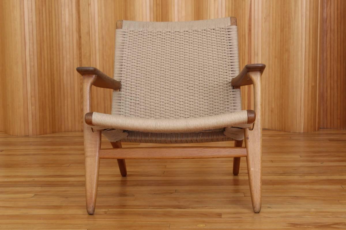 Description: Oak lounge chair - model no. CH25

Designer: Hans J Wegner

Manufacturer: Carl Hansen & Son, Odense, Denmark.

Date: 1950

Dimensions: width 75cm x depth 70cm x height 72cm

Condition: Excellent, vintage condition. The oak