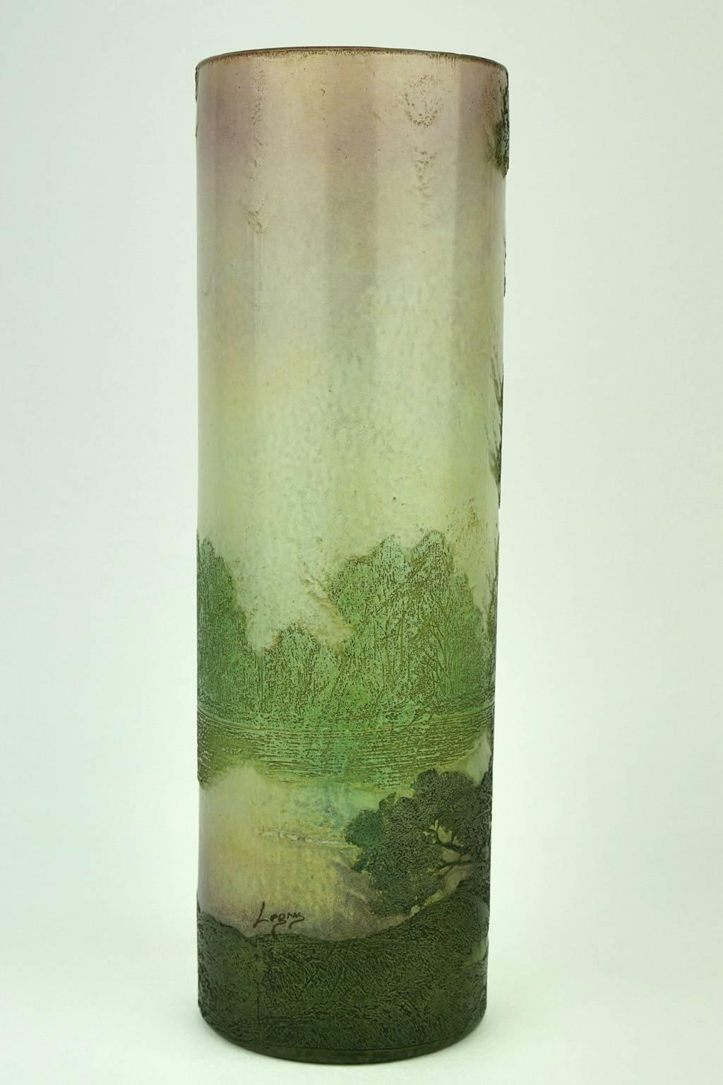 This Art Nouveau cameo vase by Legras features a landscape of pines around a lake in a clearly Japanese style.
The vase is signed Legras.