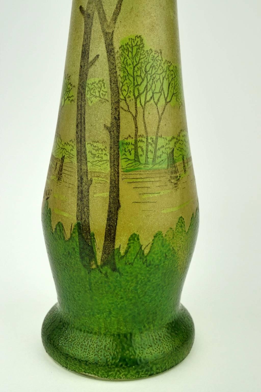 Art Nouveau enameled vase by Legras with a very peculiar shape reminiscent of berluzes.
Size. Diameter top: 6 cm. Diameter bottom: 10 cm. Height: 41.5 cm.