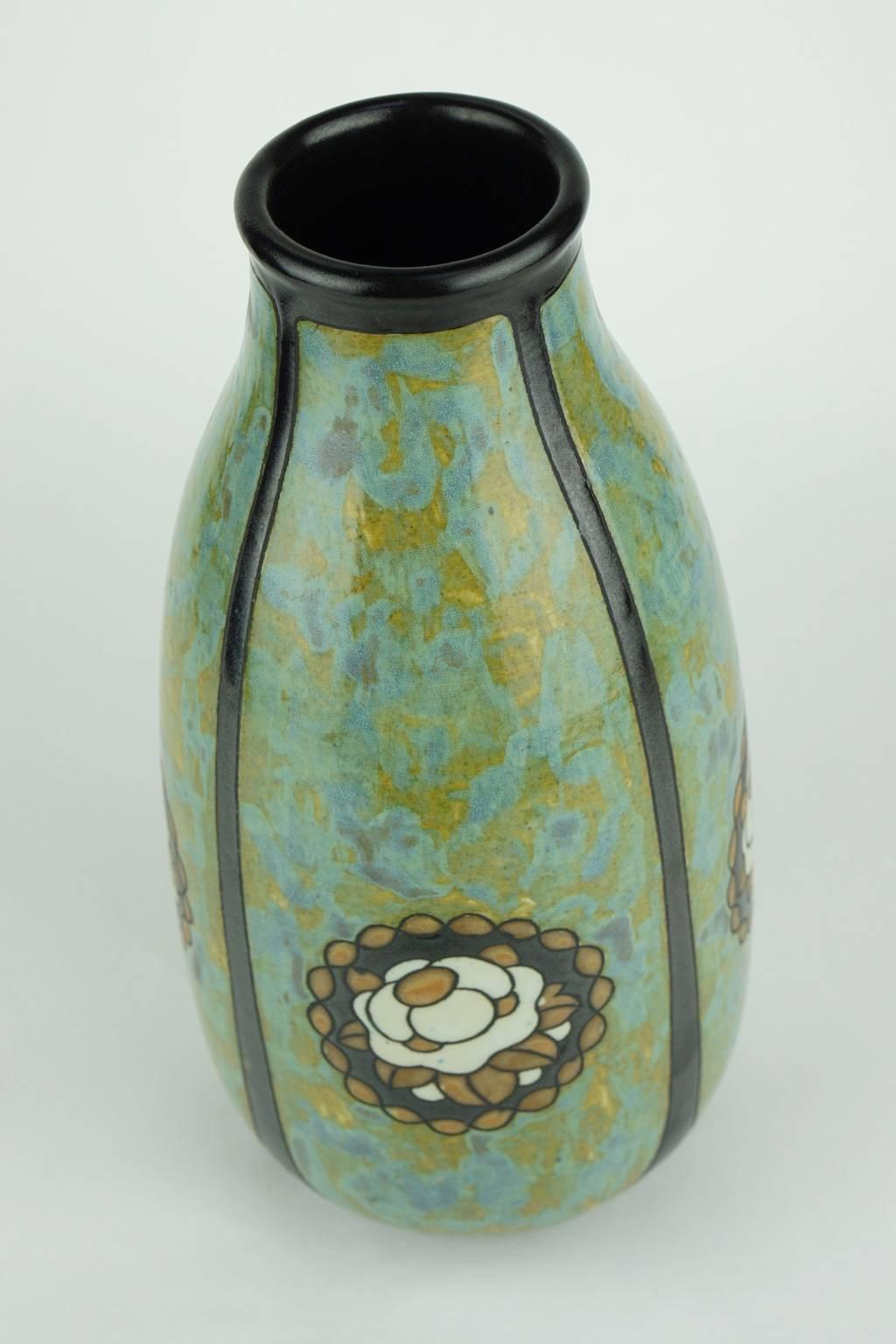 Matte stoneware Art Deco vase signed Ch. Catteau. Design 771. The design is made of floral medallions on marbled background each in one of four quartets. (Form 396).

Size: H 27 cm, diameter base 9 cm, diameter top 6 cm.