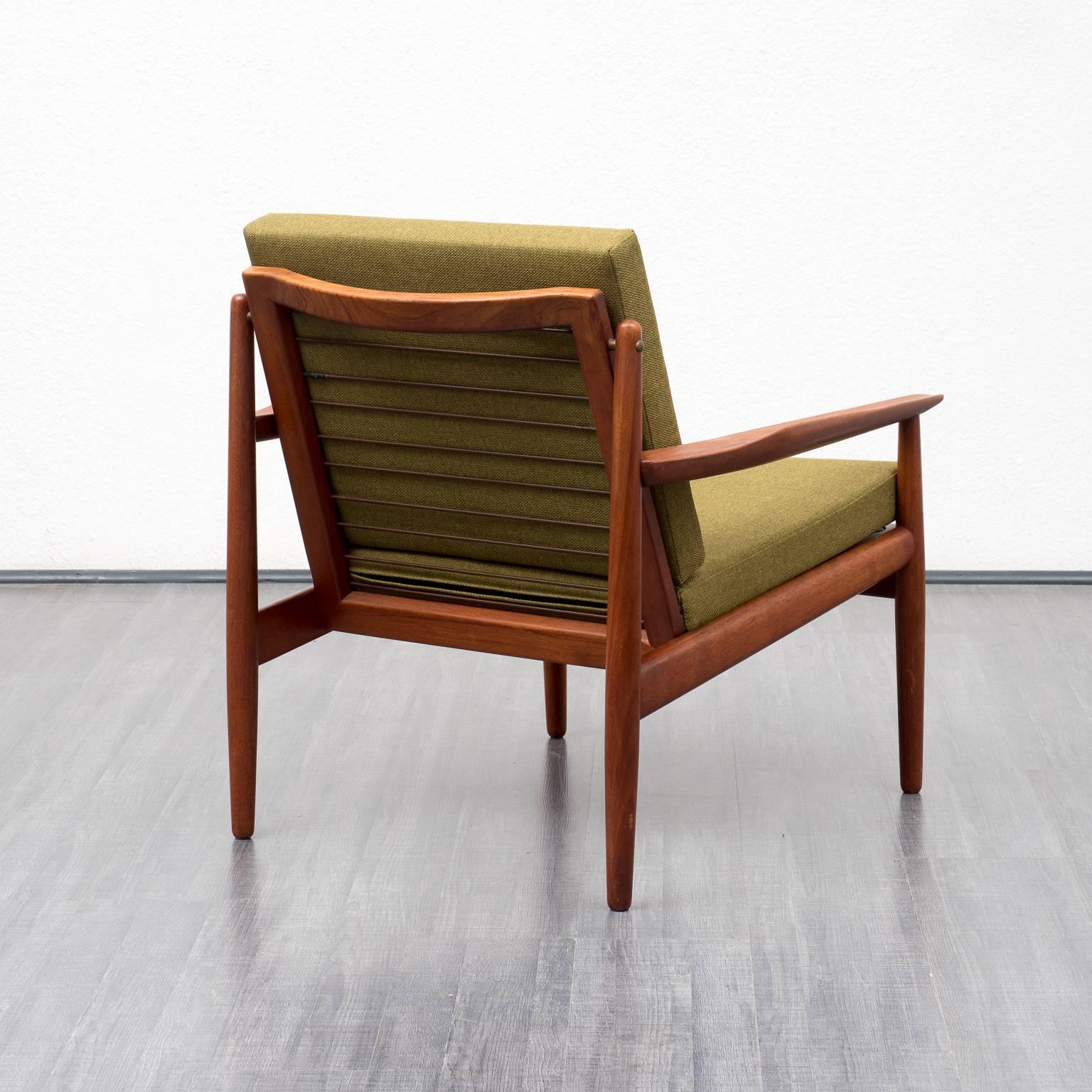 Elegant armchair from the 1960s. Made in Denmark. Design by Arne Vodder for Glostrup, Denmark. Shapely, solid teak wood frame with nice armrests. The armchair was professionally reupholstered and covered with a high-quality green upholstery