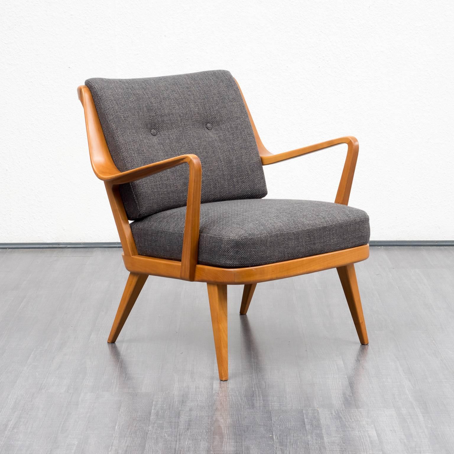 Beautiful, Classic armchair from the 1950s by Knoll Antimott. Solid cherrywood frame with shapely armrests. Very comfortable due to the innerspring seating cushions. The armchair was professionally upholstered and covered with a high-quality,