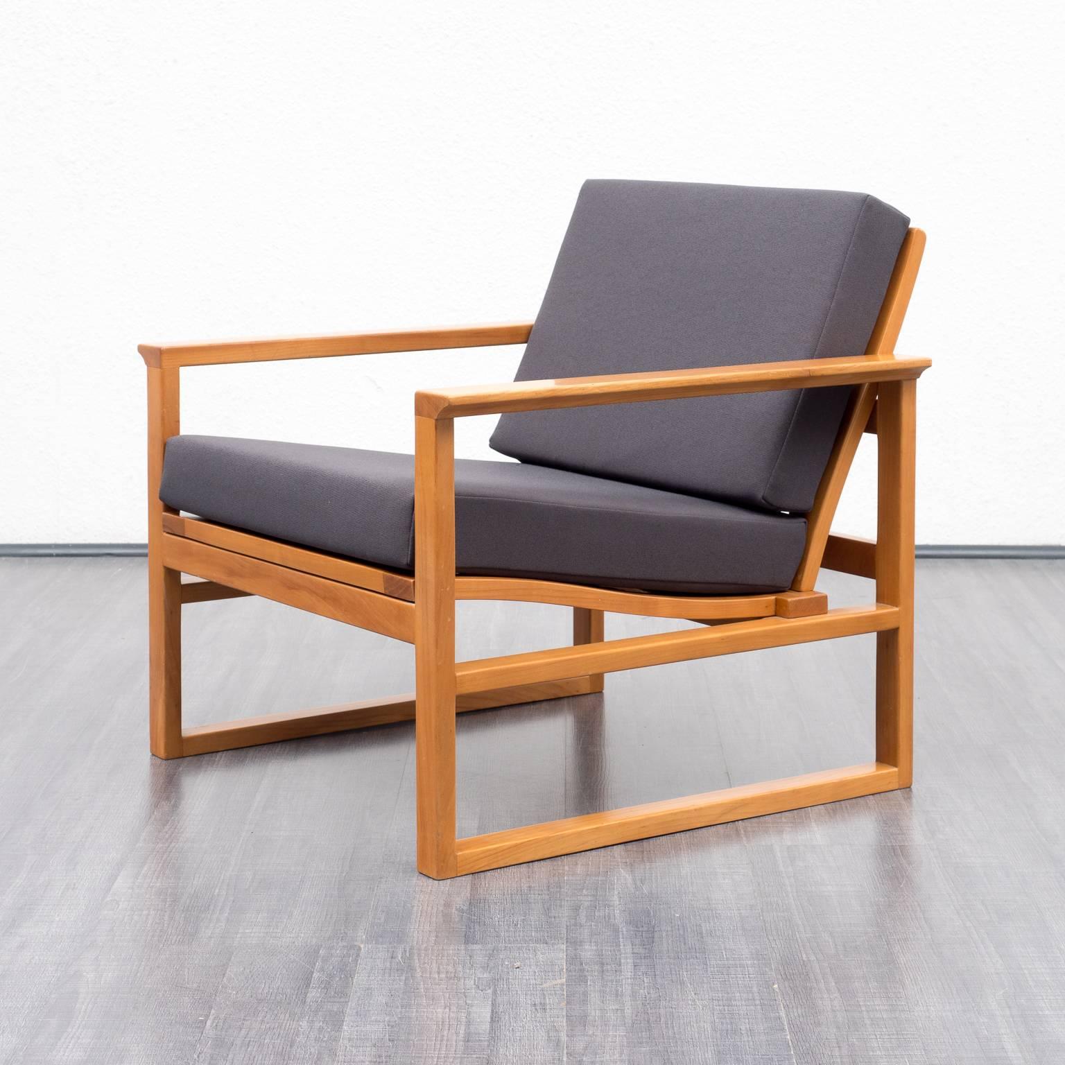High-quality armchair with footrest from the 1950s, Danish design in the style of Børge Mogensen. Solid cherrywood frame with mortise and tenon. Armchair and footrest have been professionally reupholstered and covered with a high-quality,