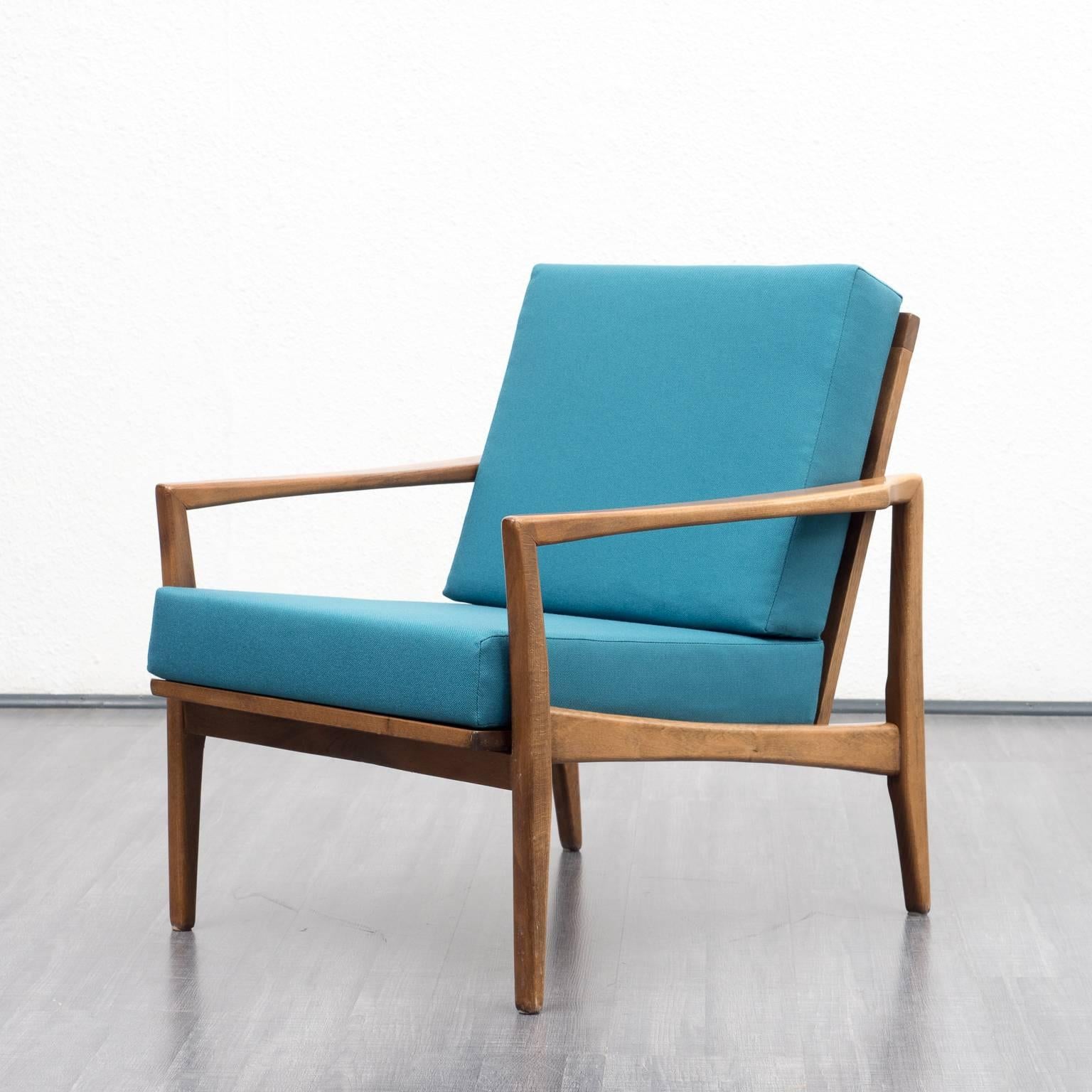 Beautiful, Classic armchair from the 1960s. Shapely solid beechwood frame. The armchair was professionally reupholstered and covered with a high-quality petrol blue cushion fabric.