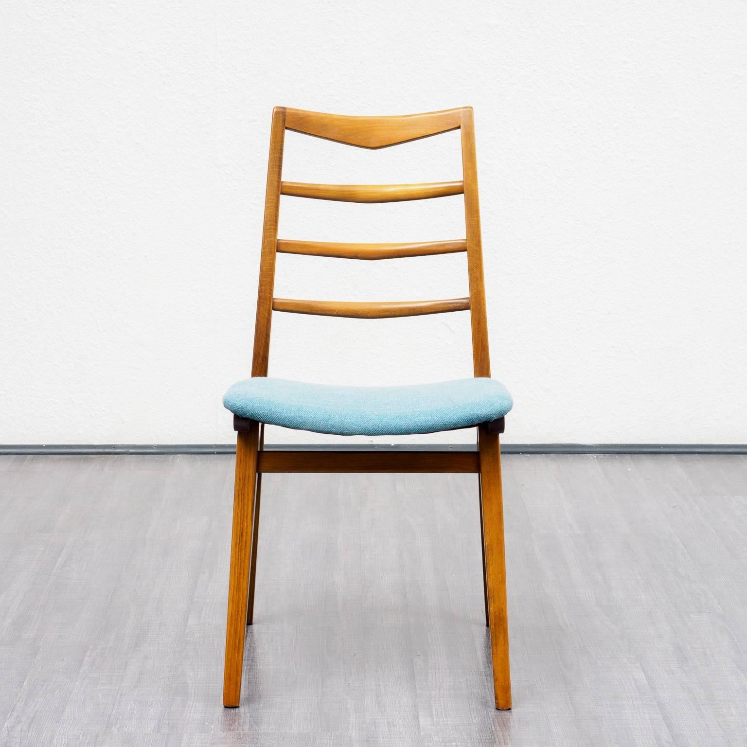 Set of four dining chairs from the 1960s. Solid beechwood frame, nice workmanship. Professionally reupholstered and covered with a high-quality dove blue / white mottled upholstery fabric.

Good condition with small traces of usage.