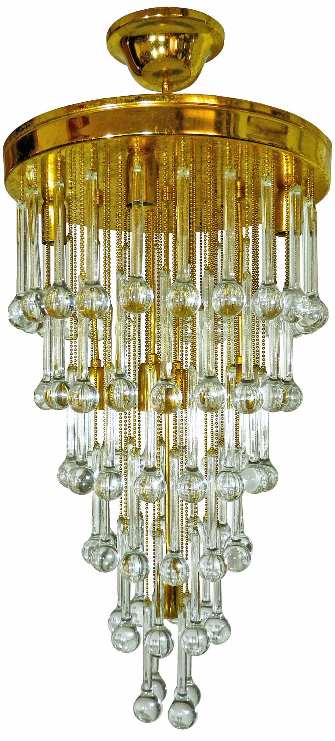 Stunning crystal waterfall wedding cake chandelier with nine-light flush mount chandelier, attributed to Ernst Palme. The piece is gold-plated and detailed with six layers of clear crystal elongated teardrop shaped prisms.
Measures:
Diameter 16 in