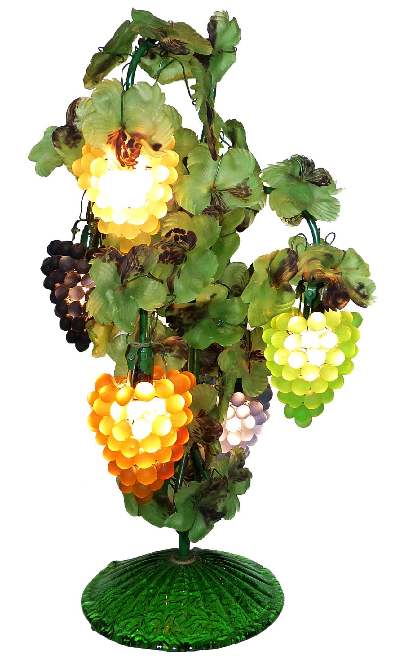 This a fabulous heavy five-light Venetian glass grape bunch and leaf floor or table lamp mimics the shape of a vine with clustered grapes as shades, handblown applied leaves in the style of Art Nouveau. 
Blown green glass base with five different