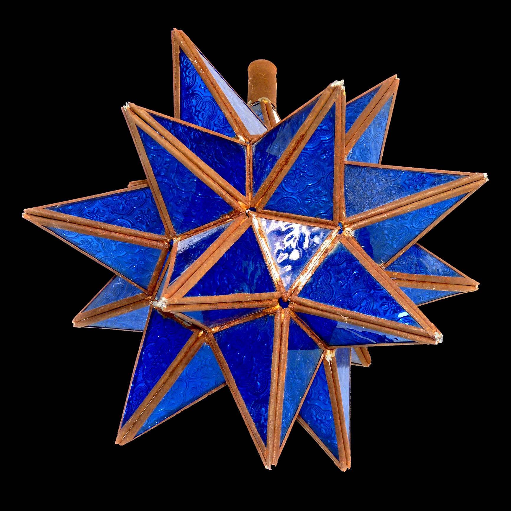 Antique handcrafted Tunisian deep blue glass pendant star shape ceiling lamp or light
unwired
Materials: Handcrafted cut-glass, handcrafted metal
Conditions: Wear consistent with age/Age patina/metal showing some rust.