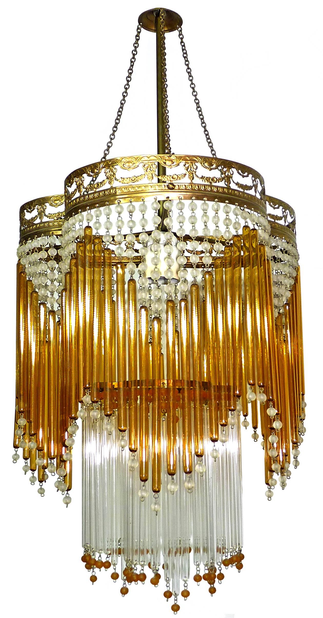 Beautiful Italian Mid-Century in clear and amber Murano beaded glass Art Deco / Art Nouveau chandelier
Measures: 
Diameter 30 cm
Height 87 cm
One light bulb E27/ good working condition/European wiring.
Age patina
Also have matching chandeliers