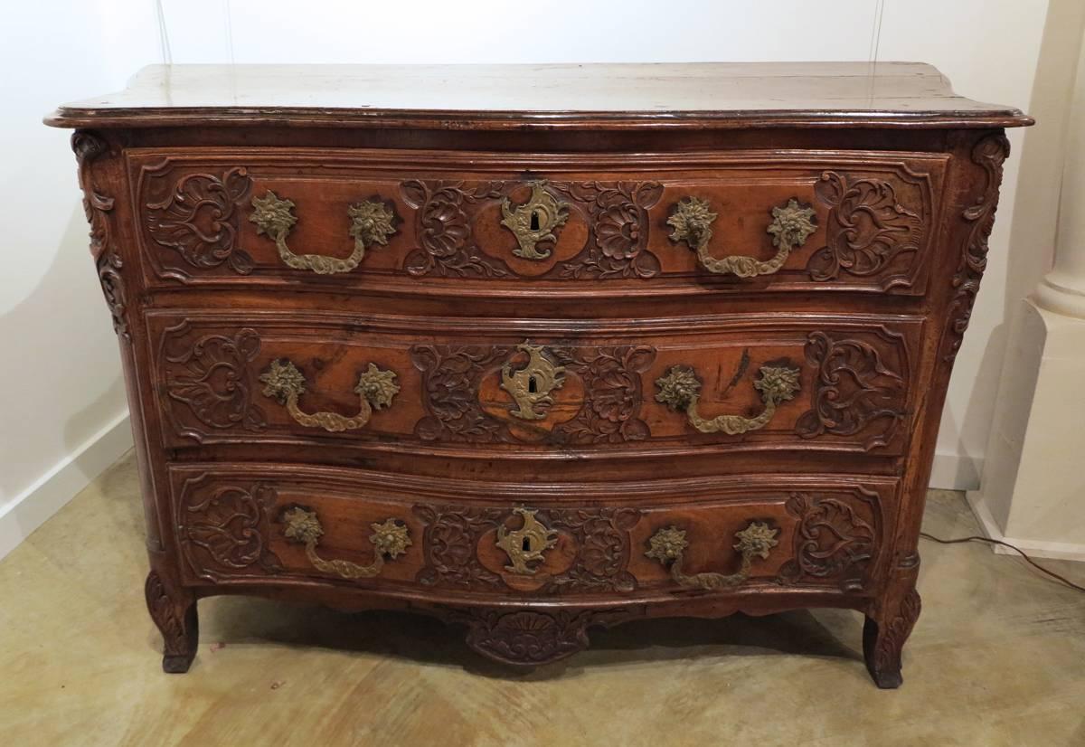 A fine and rare Louis XV 
Carved walnut and oak commode
France
Mid-18th century

The shaped top over a bombe case with three carved drawers all resting on carved feet.

Height 39 in. width 61 ½ in. depth 28 in. 

Provenance:
Property from the