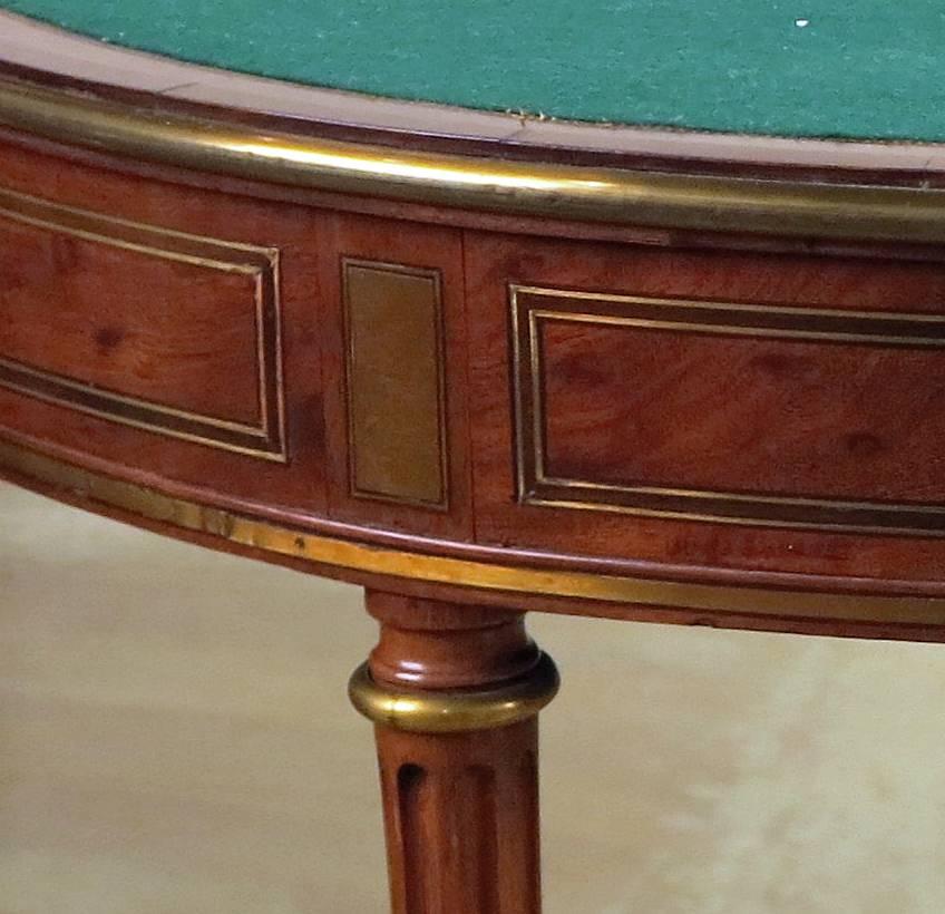 A fine Louis XVI brass-mounted
Ebony & Acajou Mouchete games table
18th century
Stamped Godefroy Dester

Godefroy Dester maitre, 1774

Measures: Height 30 in., width 43 in., depth 21 ½ in.
Diameter when open 43 in.

This ebeniste was