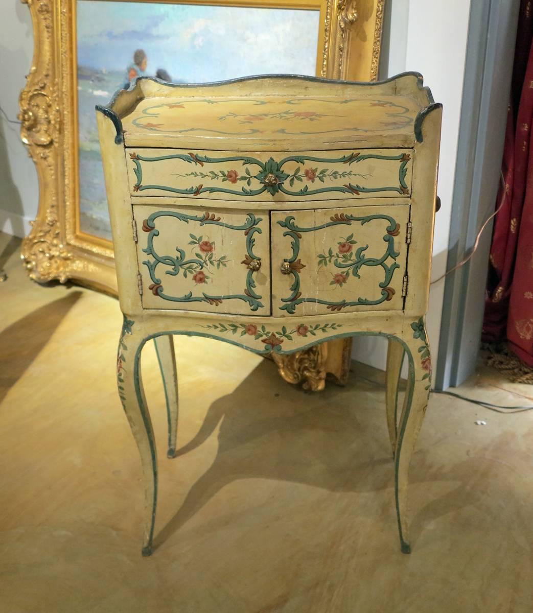 An Italian Venetian Louis XV painted stand
18th century 

Decorated throughout with a single drawer over two cupboard doors all on cabriole legs.

Measures: Height 33 in, width 20 in, depth 20 in. 

Provenance:
Private Collection New