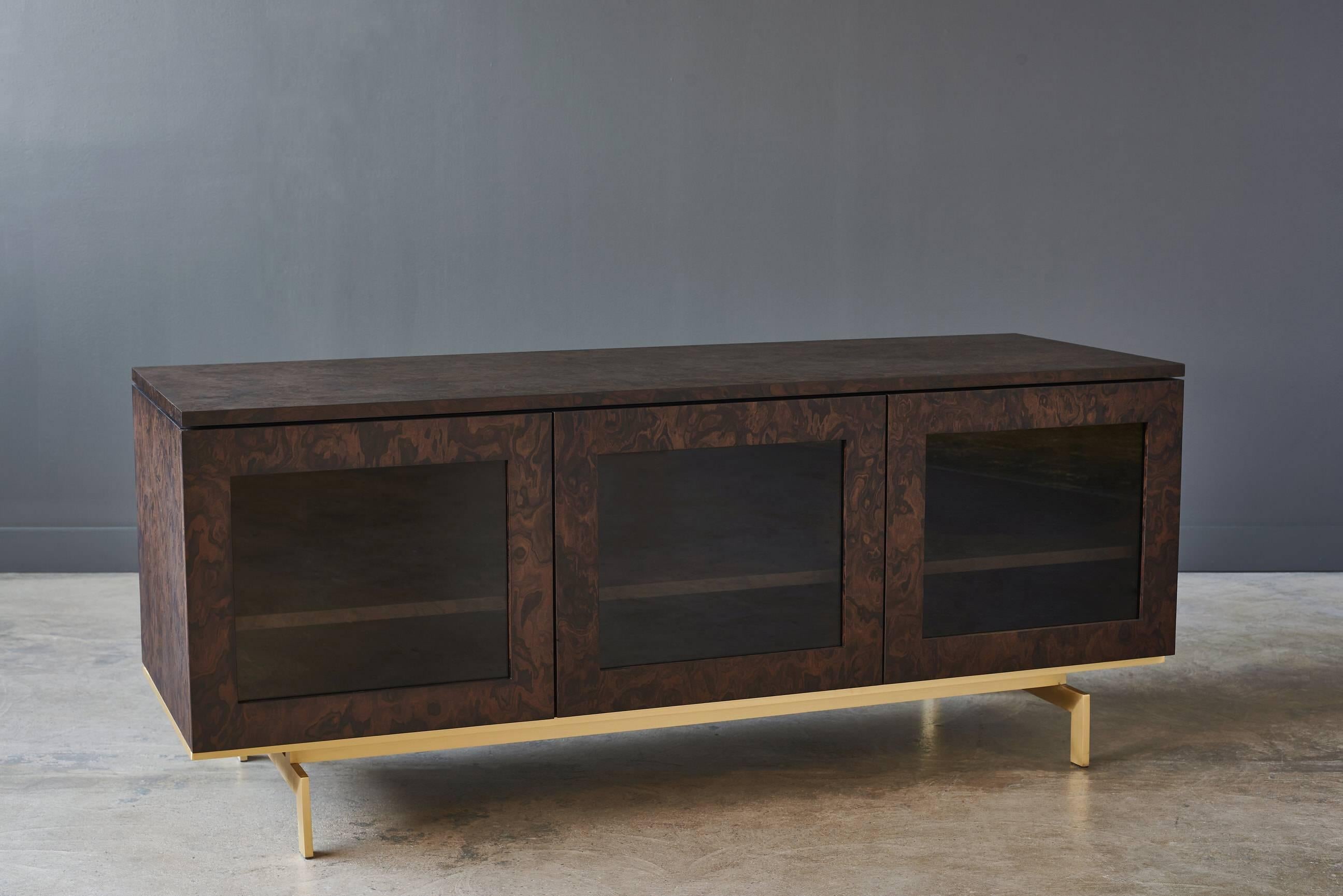 Elevate your home with the clean lines of our Darin Credenza. It is handcrafted with burled walnut, brass and clear glass front.

Shown in burled walnut case, matte brass base and clear glass. Measures: 63in x 22in x 26in H.

Each Desiron piece is