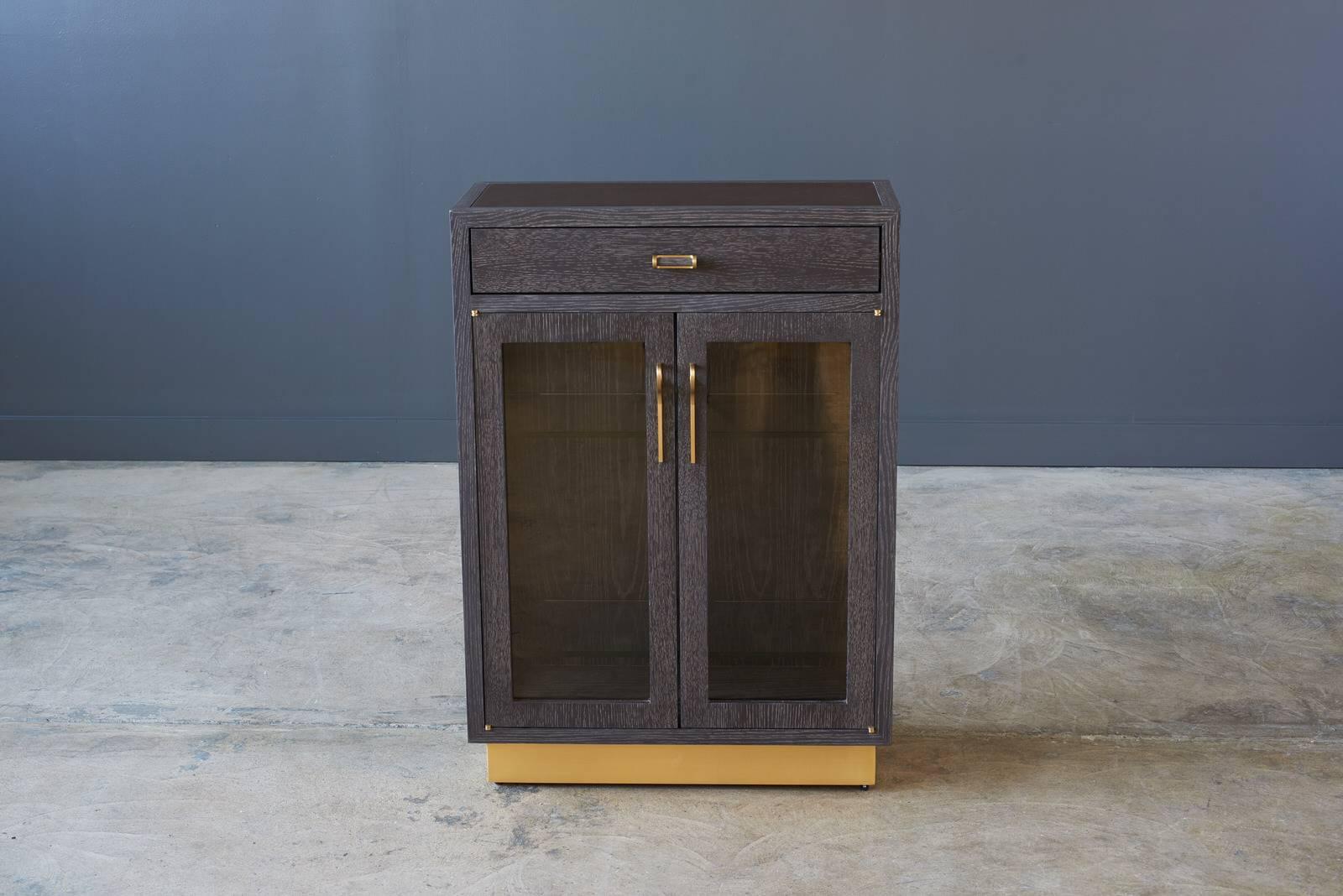 Shown in Bark Oak, Matte Brass Base, Bronze Glass, Innovations Barcelona Walnut wrapped inset with Matte Brass Lexington pulls.
Measure: 26in x 12n x 36in H.

Each Desiron piece is handcrafted in the U.S.A., fully customizable and available in a