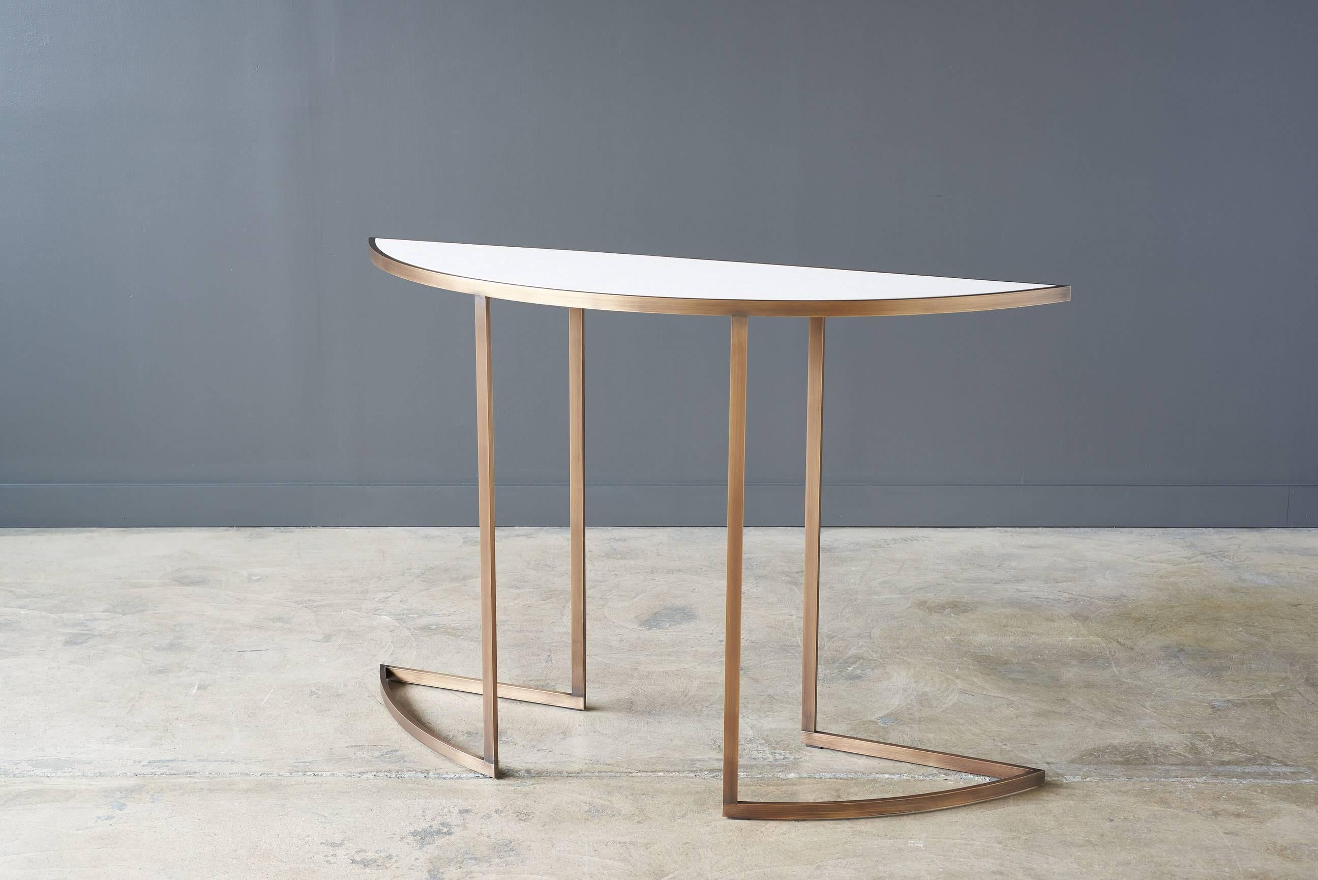 Our modern, half-moon-shaped Bleecker demilune console is a functional art piece with thoughtful handcrafted design. A well combination of simplicity and elegance to add style to any home.

Available in matte brass and innovations Tuscan sand