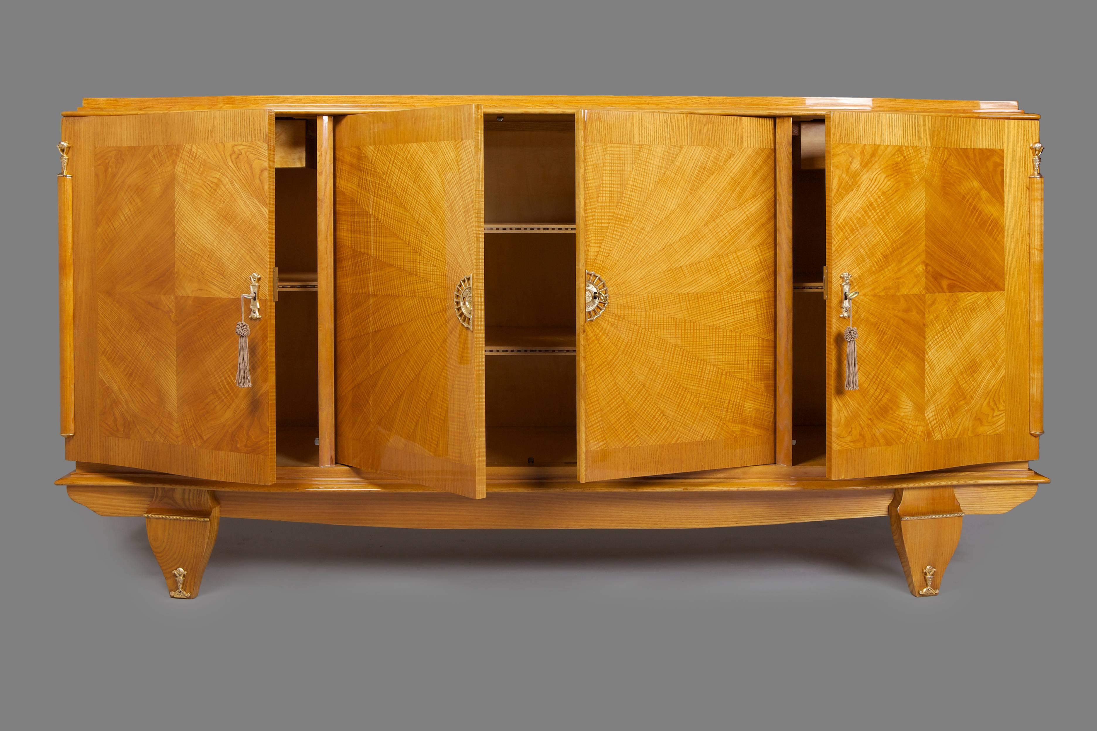 French Art Deco sideboard.
France. 
Ash-tree veneer. 
Surface was made by piano lacquers to the high gloss. 
Completely restored.