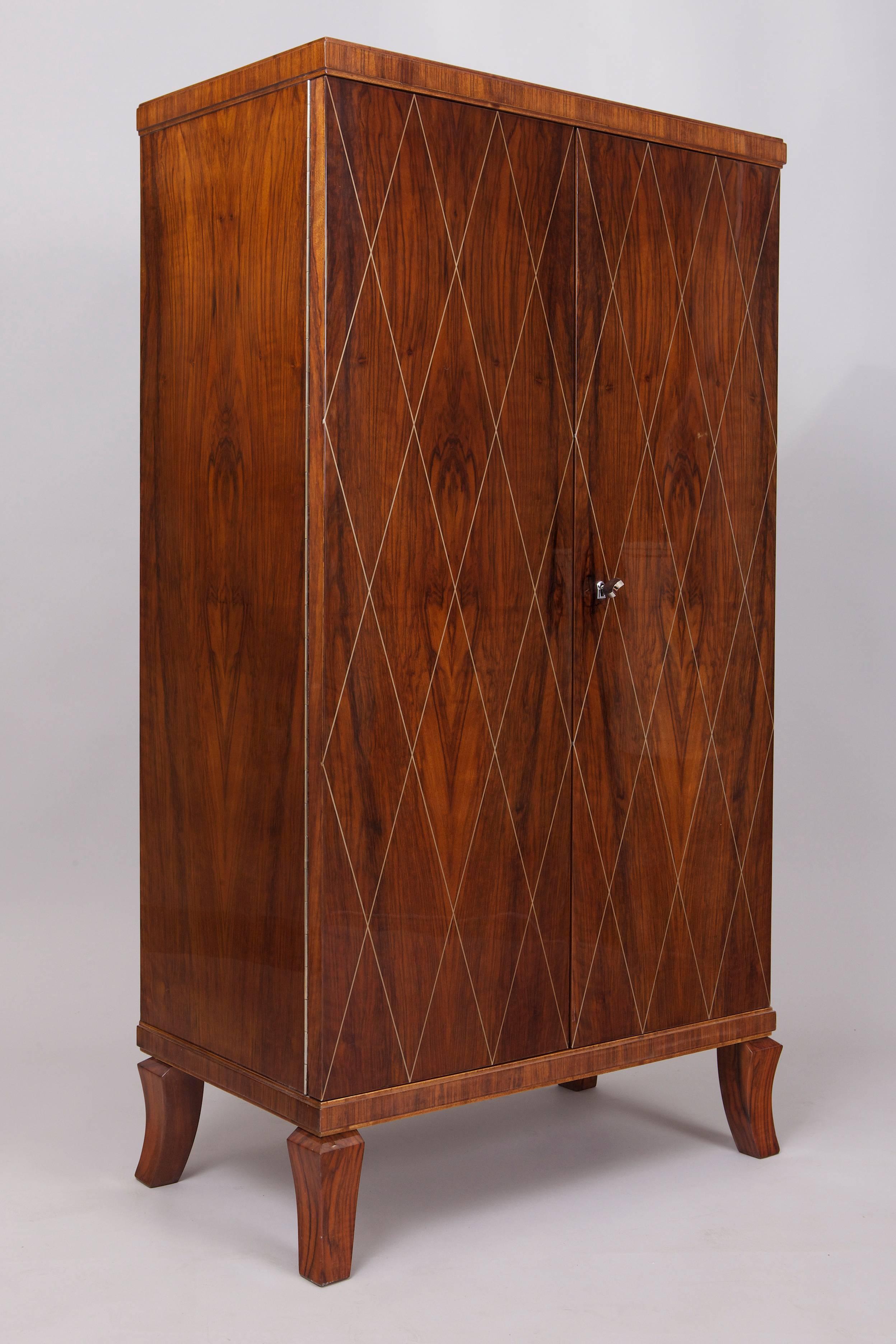Frech Art Deco bar (cabinet).
Bar cabinet basis of the draft of Jacques-Émile Ruhlmann. Walnut veneer decorated by inlaid silver lines.
Completely restored, surface was made by piano lacquers to the high gloss. 
New inside lighting - turn on when