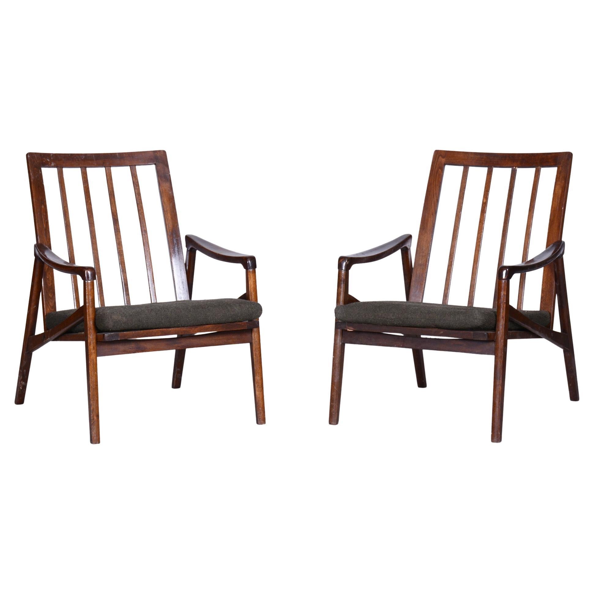 Pair of midcentury armchairs.

Period: 1960-1969
Source: Czechia (Czechoslovakia)
Material: Stained beech, fabric

Revived polish.
Stable construction from solid beech.
Professionally cleaned original upholstery.