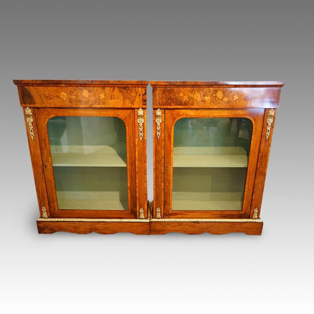 Pair of Victorian walnut pier cabinets
Here we have this pair of Victorian cabinets, made in walnut and then inlaid with kingwood banding around the doors.
Above the glazed door, is a large panel of floral marquetry, this feature makes this