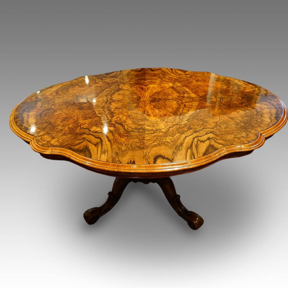 Victorian shaped walnut dining table
Here we have this Victorian shaped oval dining table
The top in fine burr walnut. The shaped oval top sits on a solid walnut carved base. The turned central column, with
Four out-swept cabriole legs, and