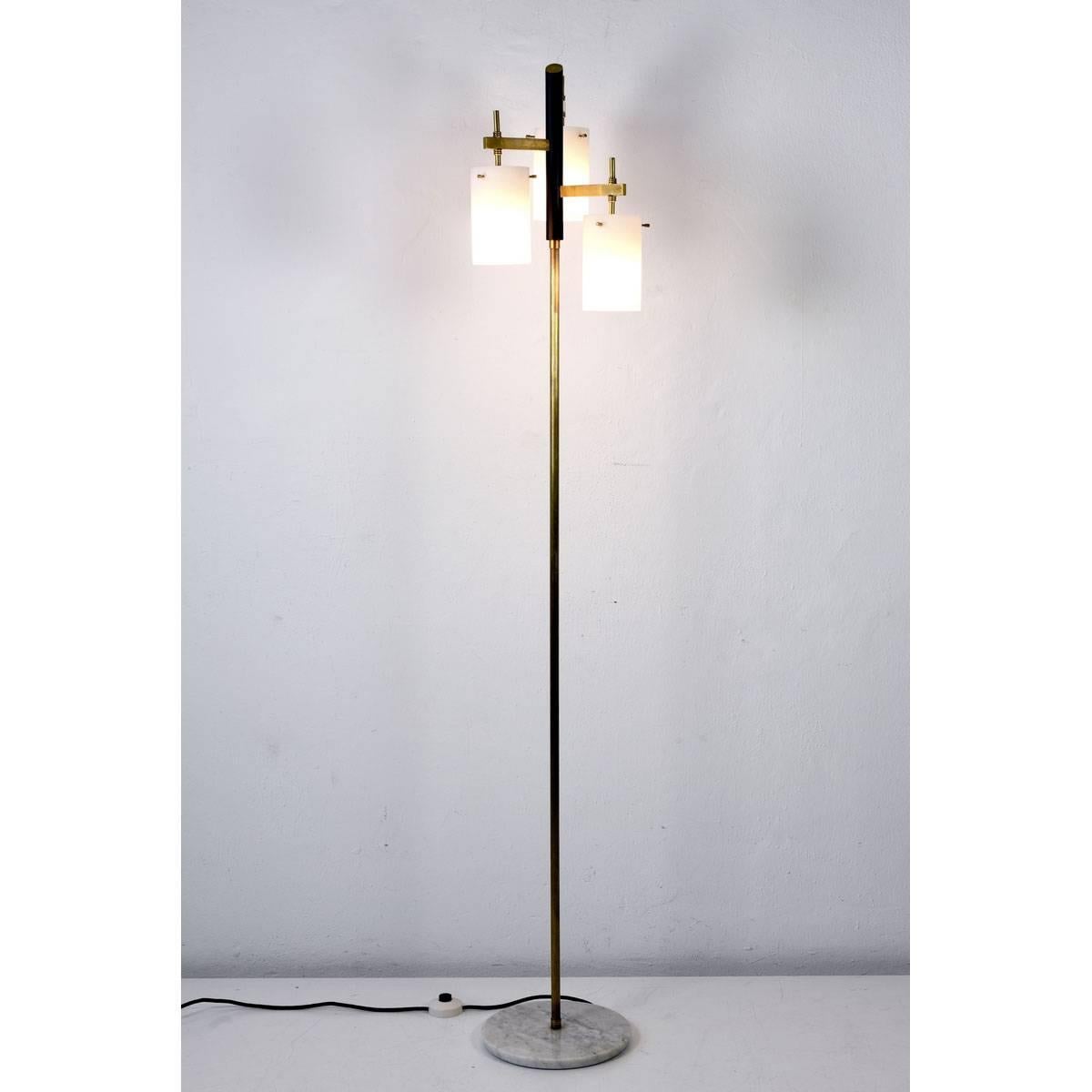 An elegant floor lamp from the Italy of the 1950s. The white-covered glass reflectors produce a fine and even light effect. The maker is most likely Stilnovo, Milano.
 