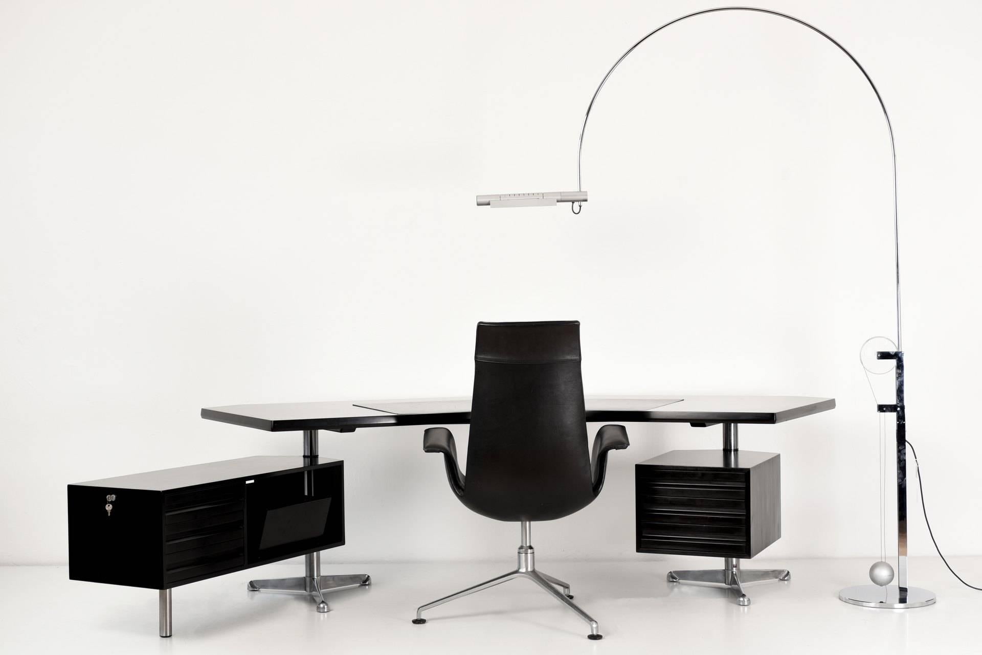 The T 96 by Osvaldo Borsani in 1956 was the most striking and completely new. The curved shape of the plate with the pivoting boxes made the desk extremely easy to use. The finely matte surface with the leather-based writing board has an elegant and