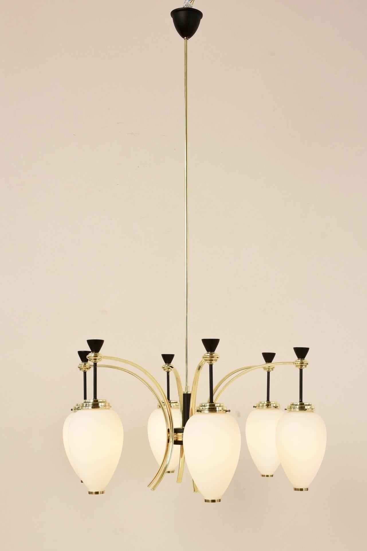This rare and splendid chandelier by Stilnovo is a representative and at the same time finely designed ceiling light. The frosted glass of the reflectors offers the best diffusion and is in Fine contrast to the polished brass of the montages and the