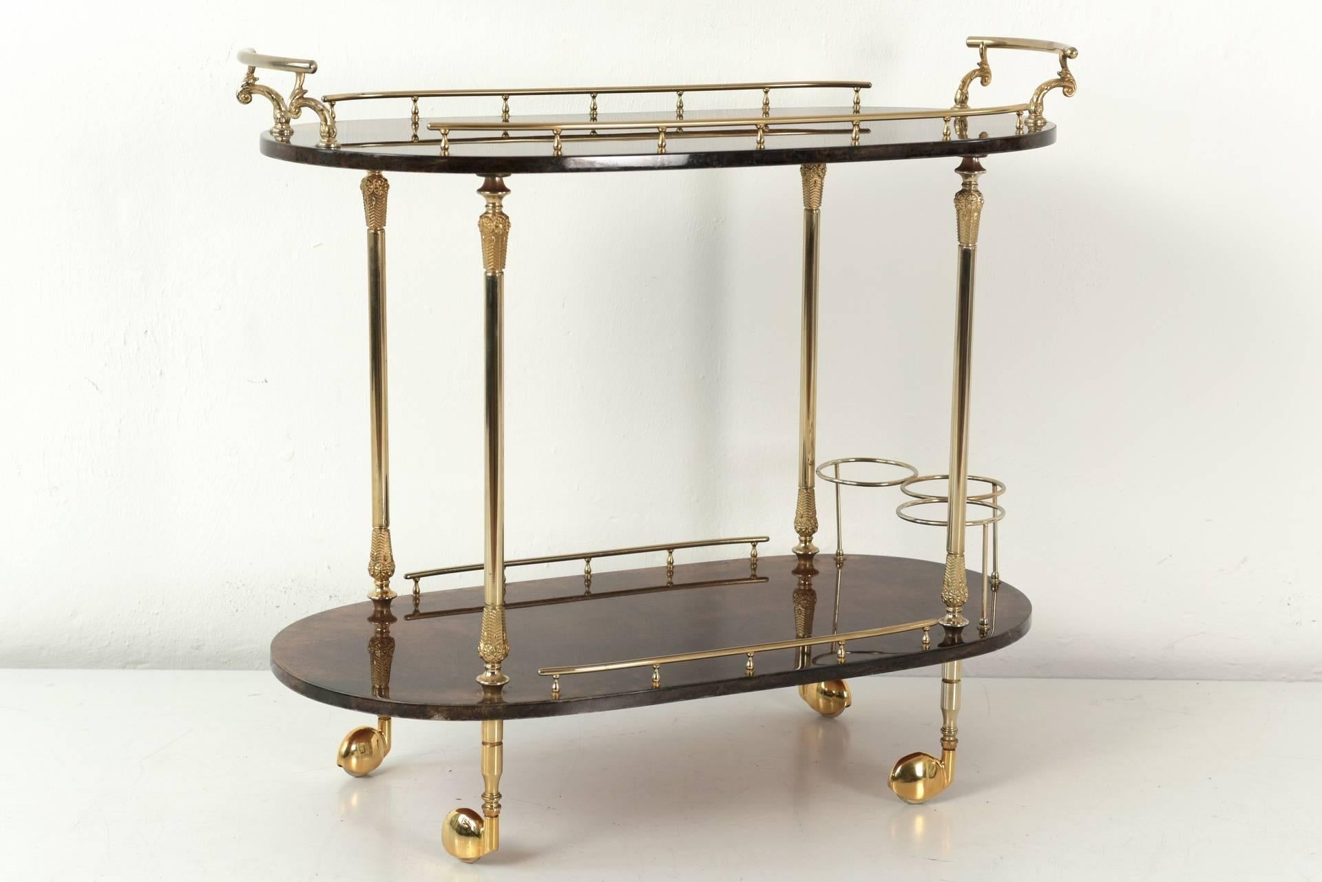 In imposing size presents this well-preserved bar cart of the manufactory Aldo Tura from Milan. Tura developed this patinated leather cover with star-durable polyester paint for the decoration of small furniture, table cabinets, etc. The combination