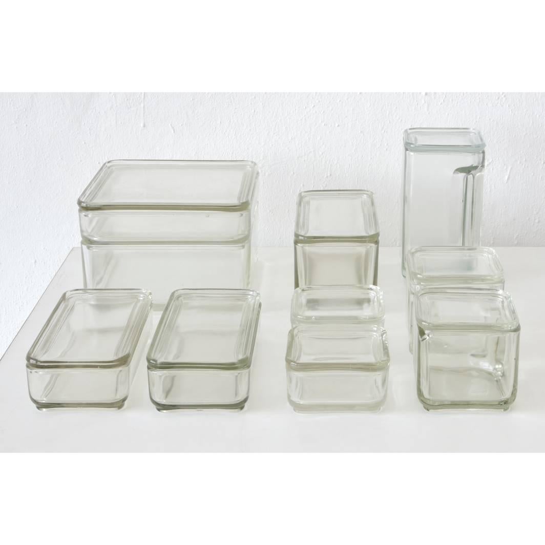 The famous Kubus glass refrigerator set by Wilhelm Wagenfeld in complete compilation. All parts original and in very good condition, no scratches or jumps.
The kitchenware was developed by Wagenfeld in the aspect of space-saving stacking for