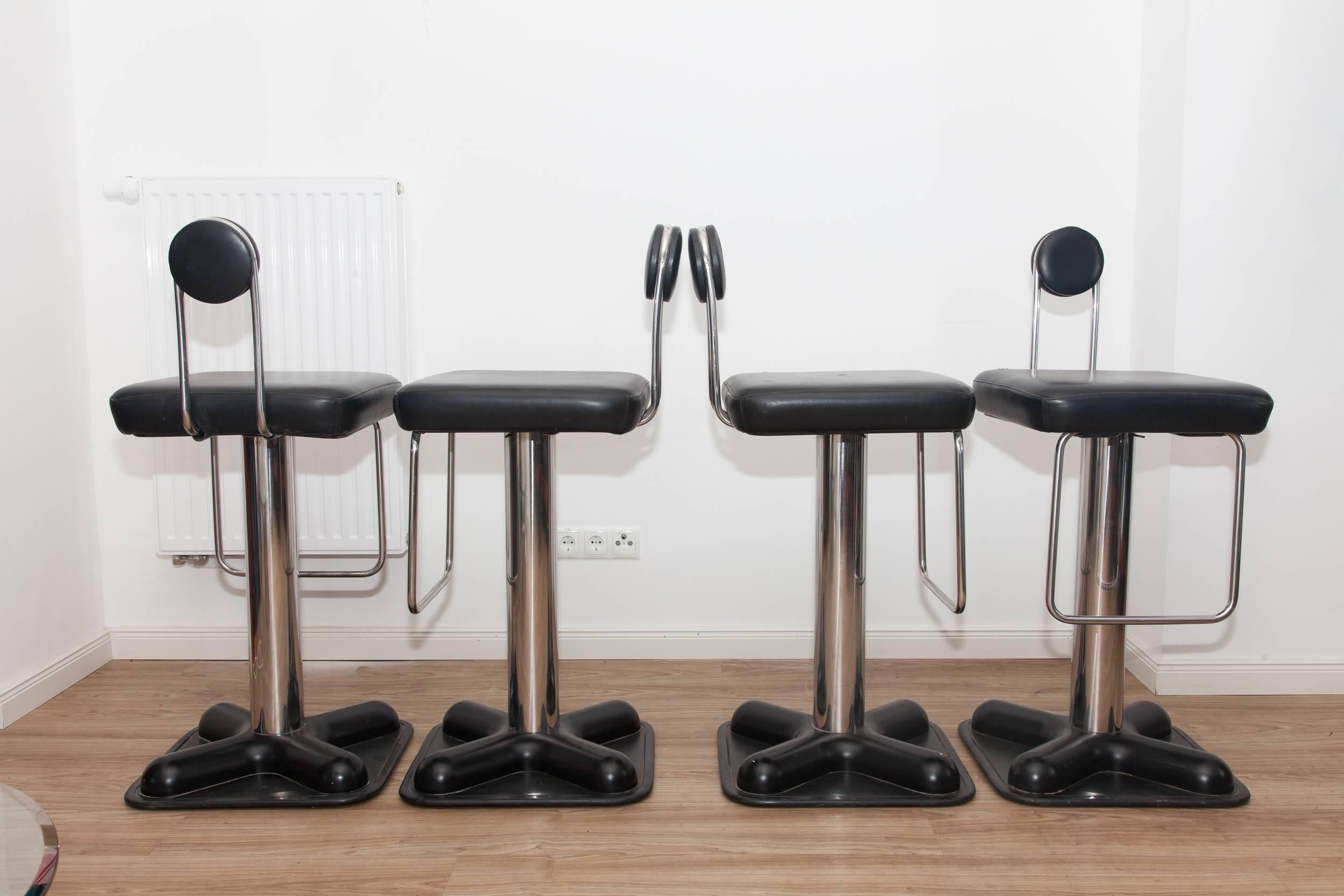 These four bar stools, model Birillo, were designed in 1971 for Zanotta. They feature black leather upholstery and a chromed metal base with a black lacquered plastic foot. The design was awarded the golden medal at the International Exhibition