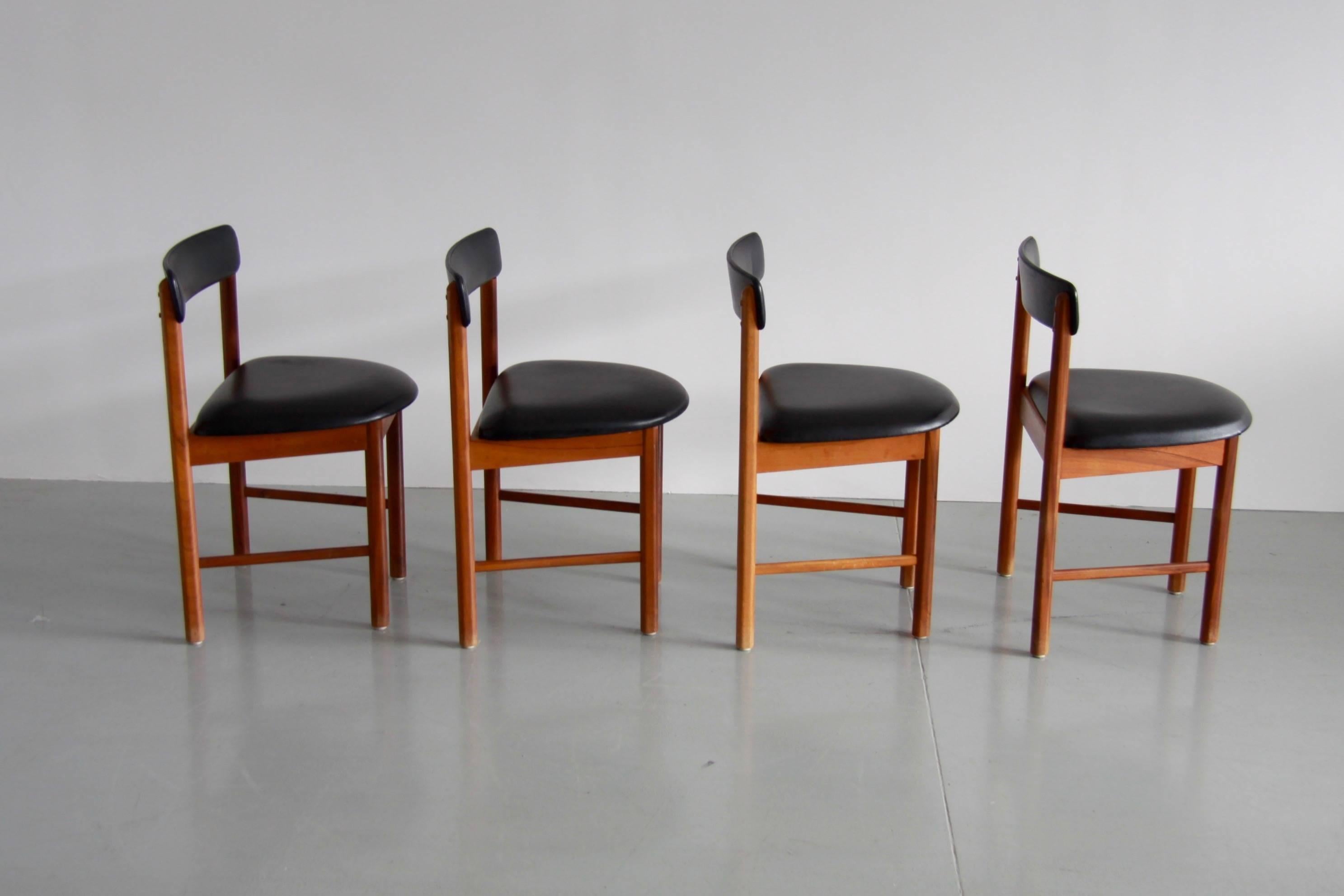 A beautifully figured rich 1960s teak four black vinyl chairs by McIntosh Scotland in very good vintage condition. 
Chairs are as original apart from being re-oiled.