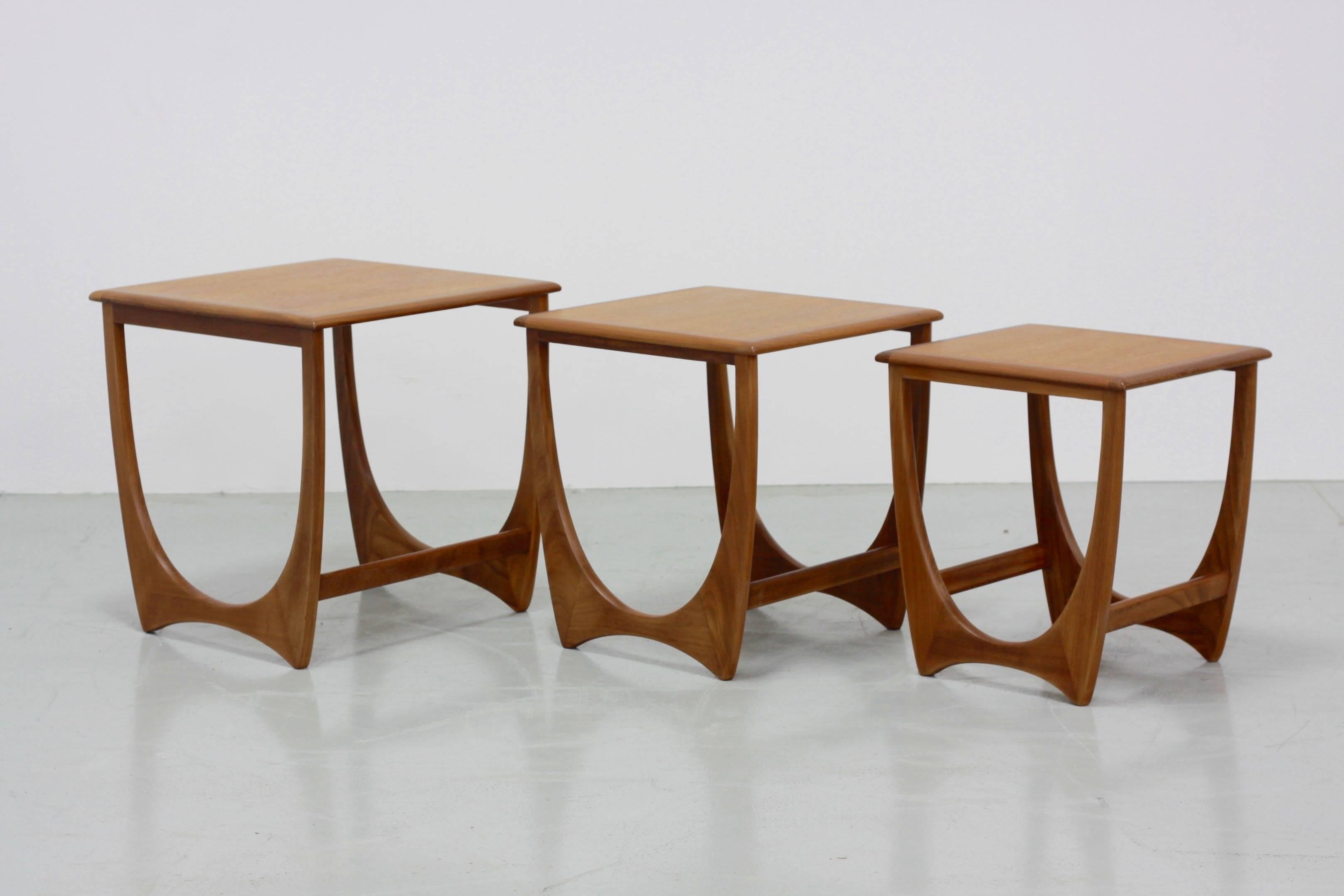This beautiful set of three Mid-Century Modern Scandinavian style nesting tables in teak, model Astro, was manufactured by G-Plan.