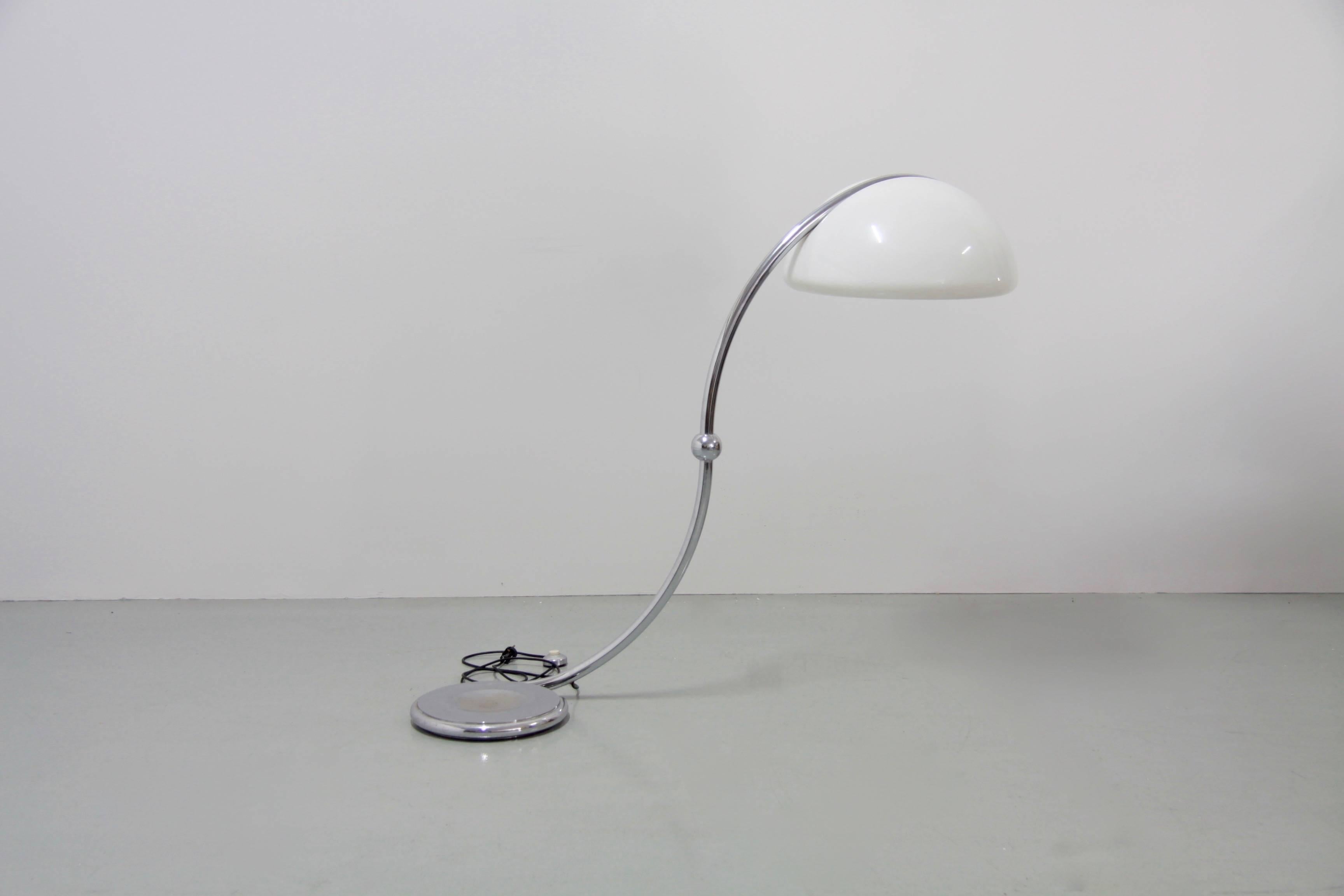 This Serpente chrome floor lamp was made by Martinelli Luce and designed by Elio Martinelli. The top half of this lamp pivots 360 degrees creating a different look each time. This piece is signed with the manufacturer's label on the bottom, and the