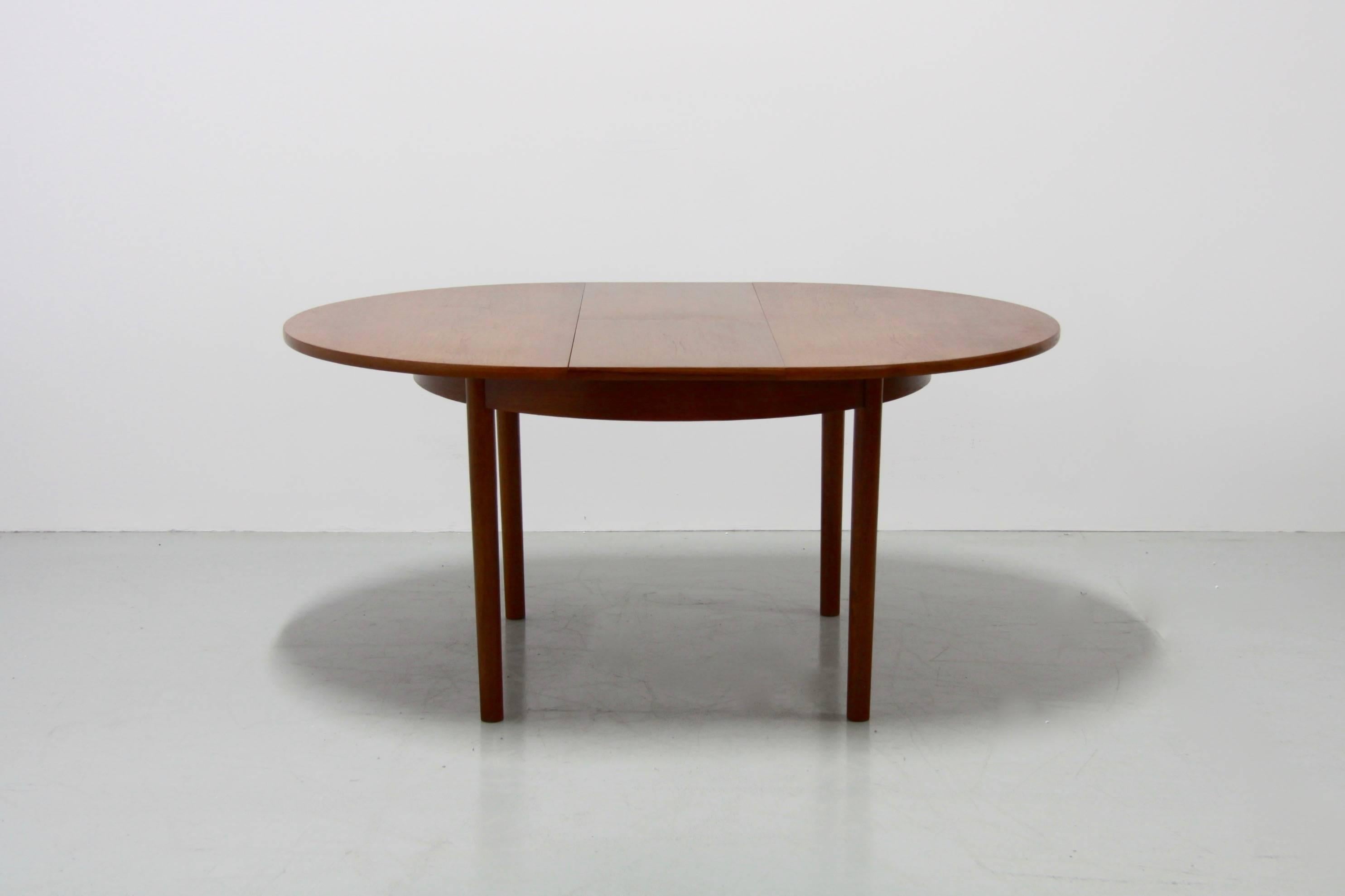 This midcentury beautiful dining table from the 1960s has an extension stored in the inside, lengthening the table to 155 cm. It has a solid teak tabletop and the table seats six people comfortably.
The chairs shown at the photos are not for sale.