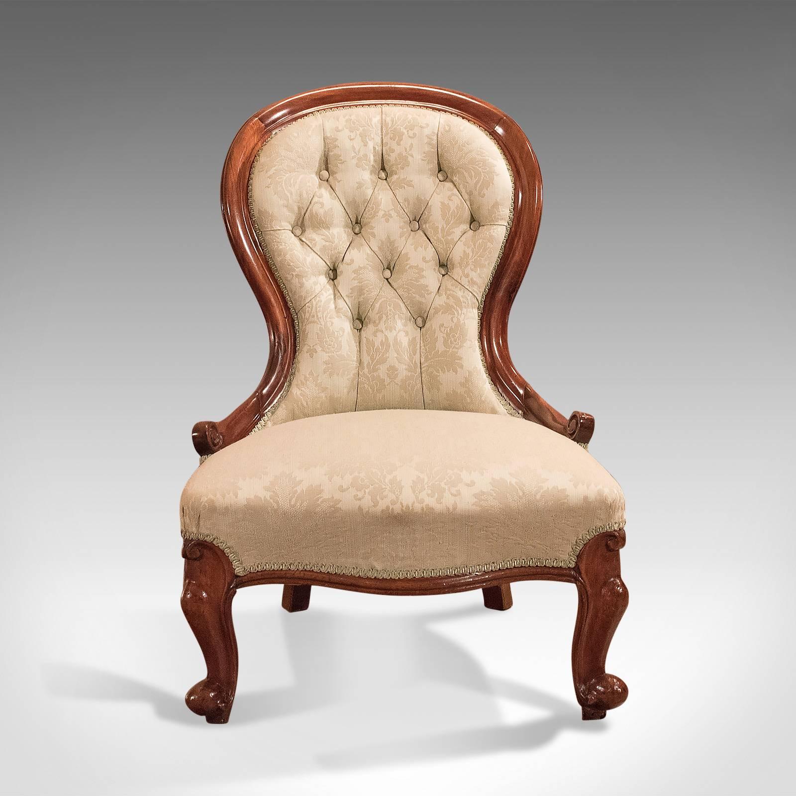 This is a Classic Victorian, antique salon chair dating to the early 19th century, circa 1840.

Raised on stout, oblique cabriole legs.
Featuring bulbous knee and scrolled toe.
Swept and shaped rear legs.

Serpentine front seat rail.
Dished