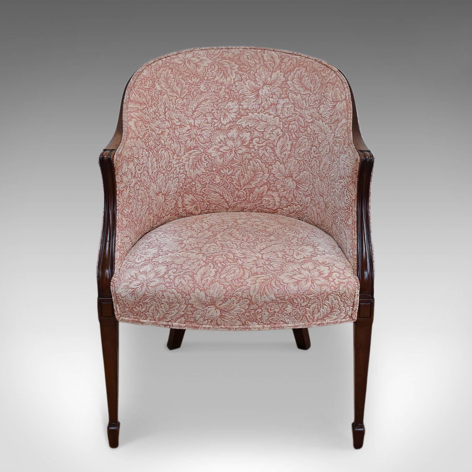 This is an antique Howard and Sons chair dating to the Victorian period.
A beautifully crafted mahogany tub chair in the Georgian manner
By the renowned maker Howard & Sons
An unusual shape rarely found on the market
Provides a