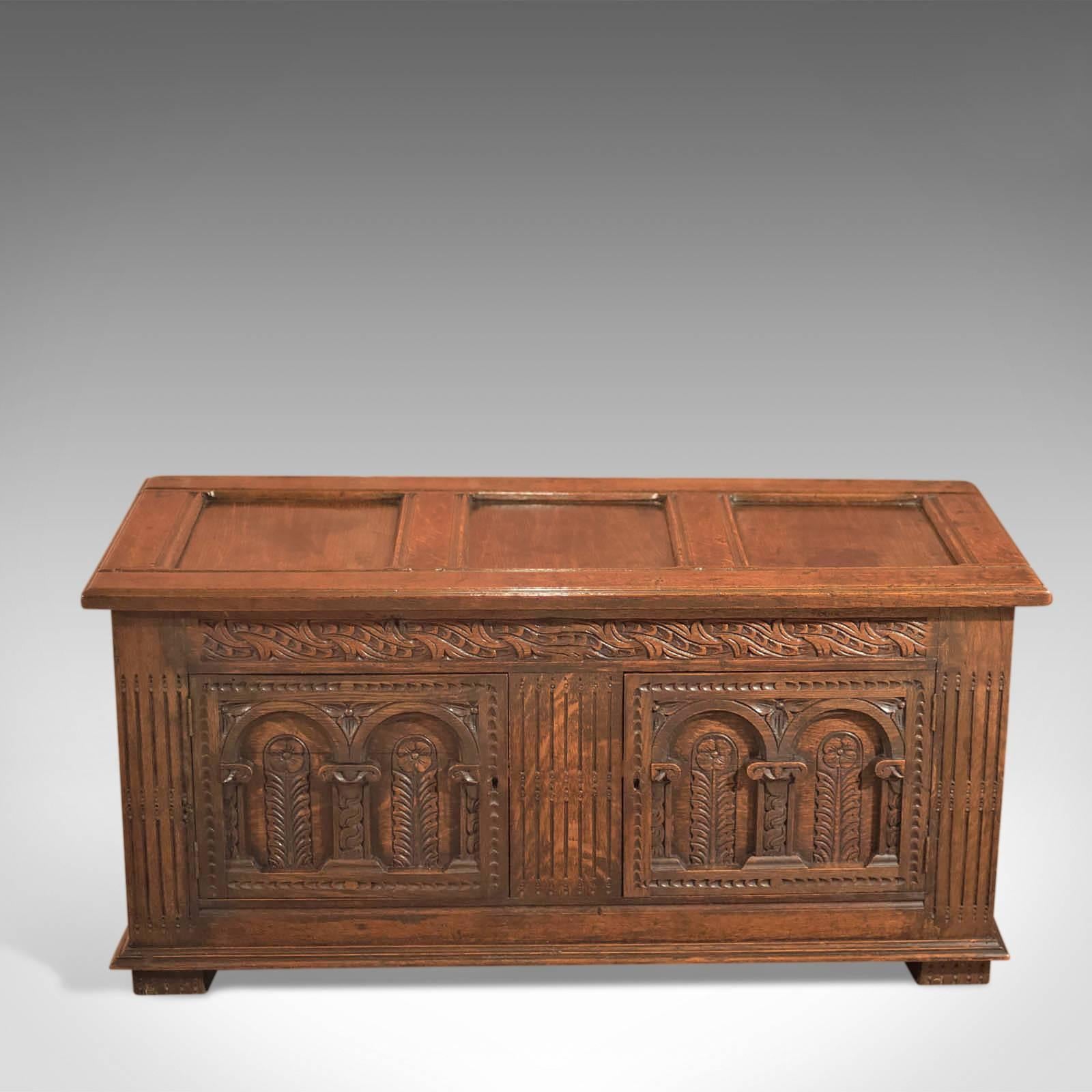 This is an antique coffer dating to the early 18th century.

The fluted stiles extend through the skirt moulding to the floor forming feet and raising the coffer a couple of inches from the ground.

Sitting below a reciprocating carved frieze