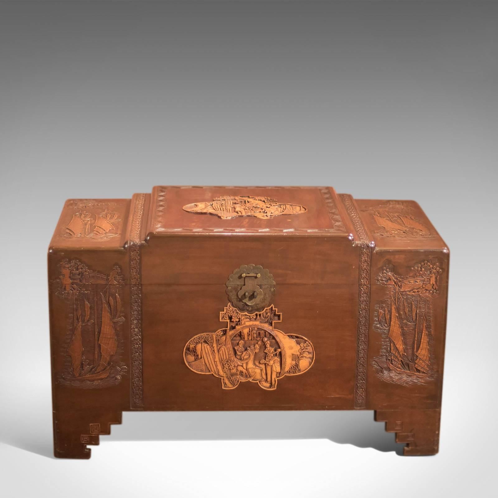 This is an early 20th century camphor wood trunk dating to circa 1930.

In a dark polished finish, this chest is raised on stepped bracket feet delineated with geometric tracery, typically found on oriental storage furniture of this type.

Each