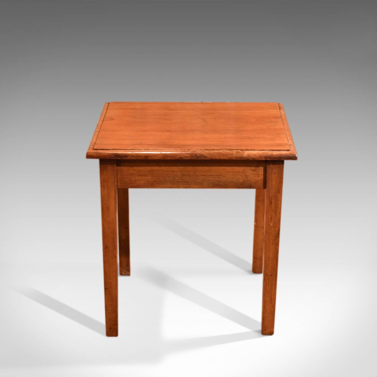 This is an antique, early 20th century side table dating to circa 1910.

Modest in form, this diminutive side table is in perfect proportion at 46cm (18 inches) in all axis.

Raised on gently tapered, square section legs united by a plain apron