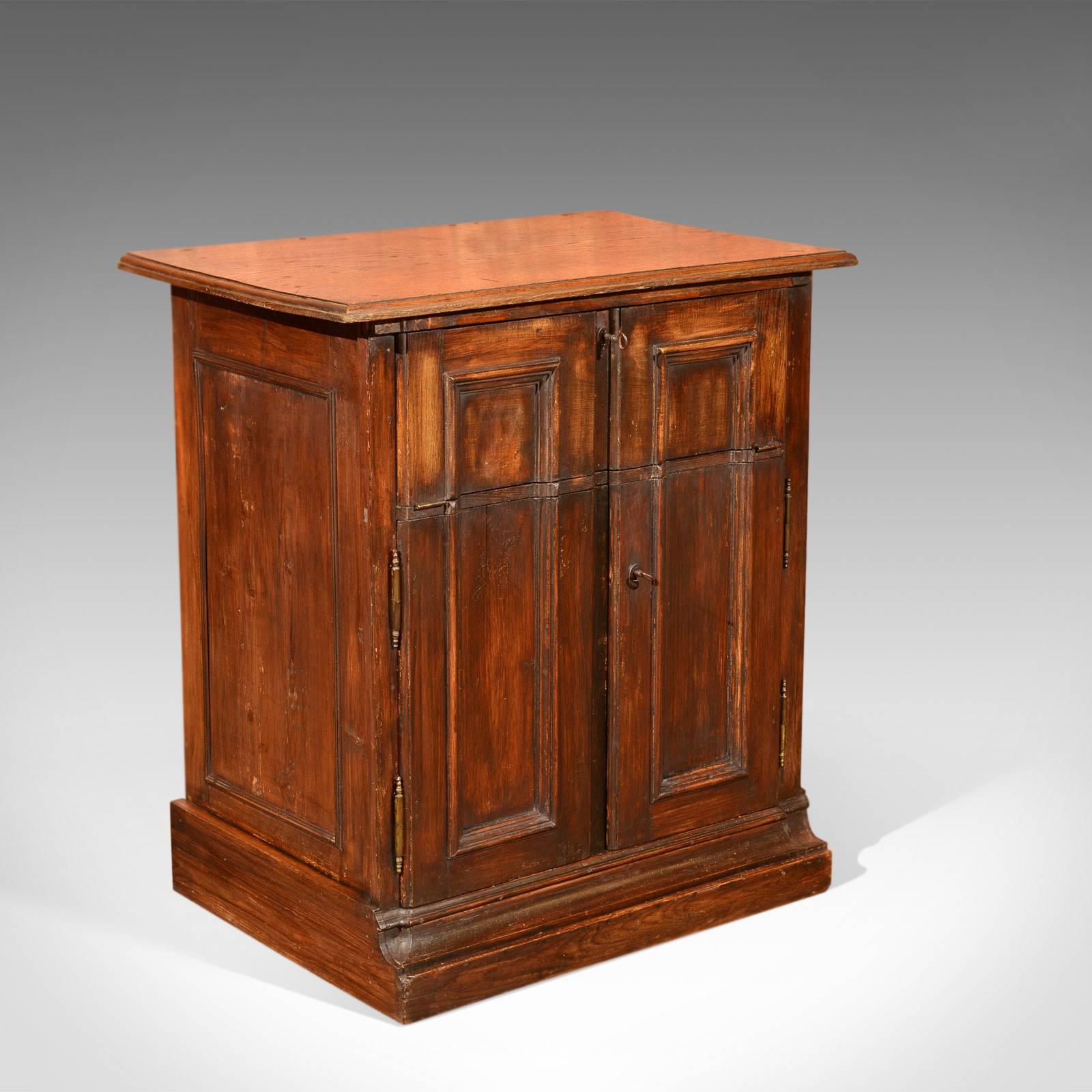 This is an antique, French, oak specimen cabinet dating to circa 1850.

In a desirable country style, this French cabinet is complete with the original working locks and keys. Made in oak and raised on a plinth base the rustic finish is full of