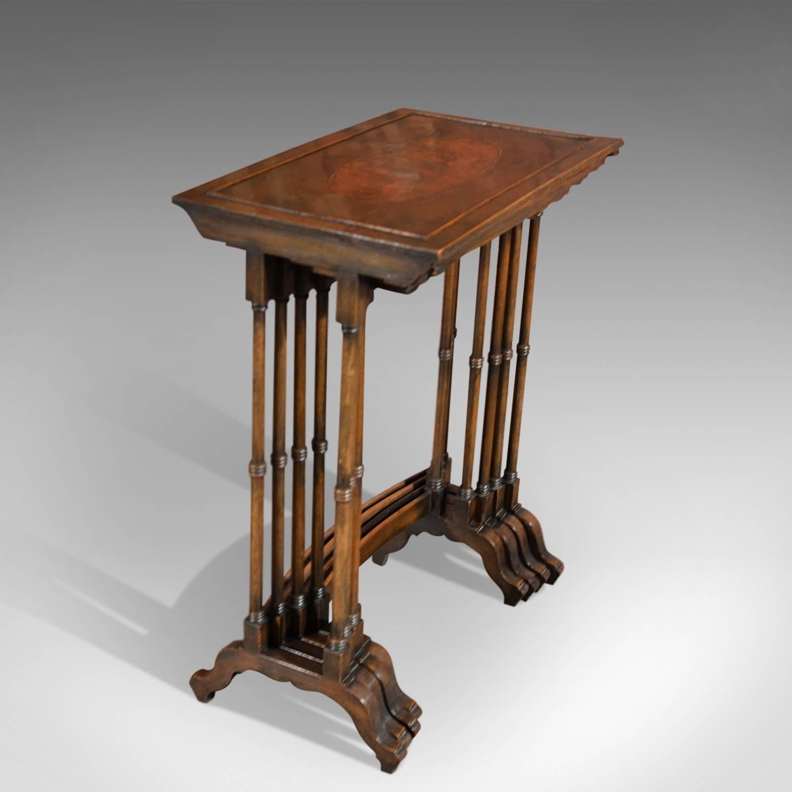 This is an walnut quartetto antique nest of tables.

Dating to the latter part of the 19th century, this rare quartetto nest of tables display superb craftsmanship seamlessly stacking within the largest table.

Each of the galleried table tops