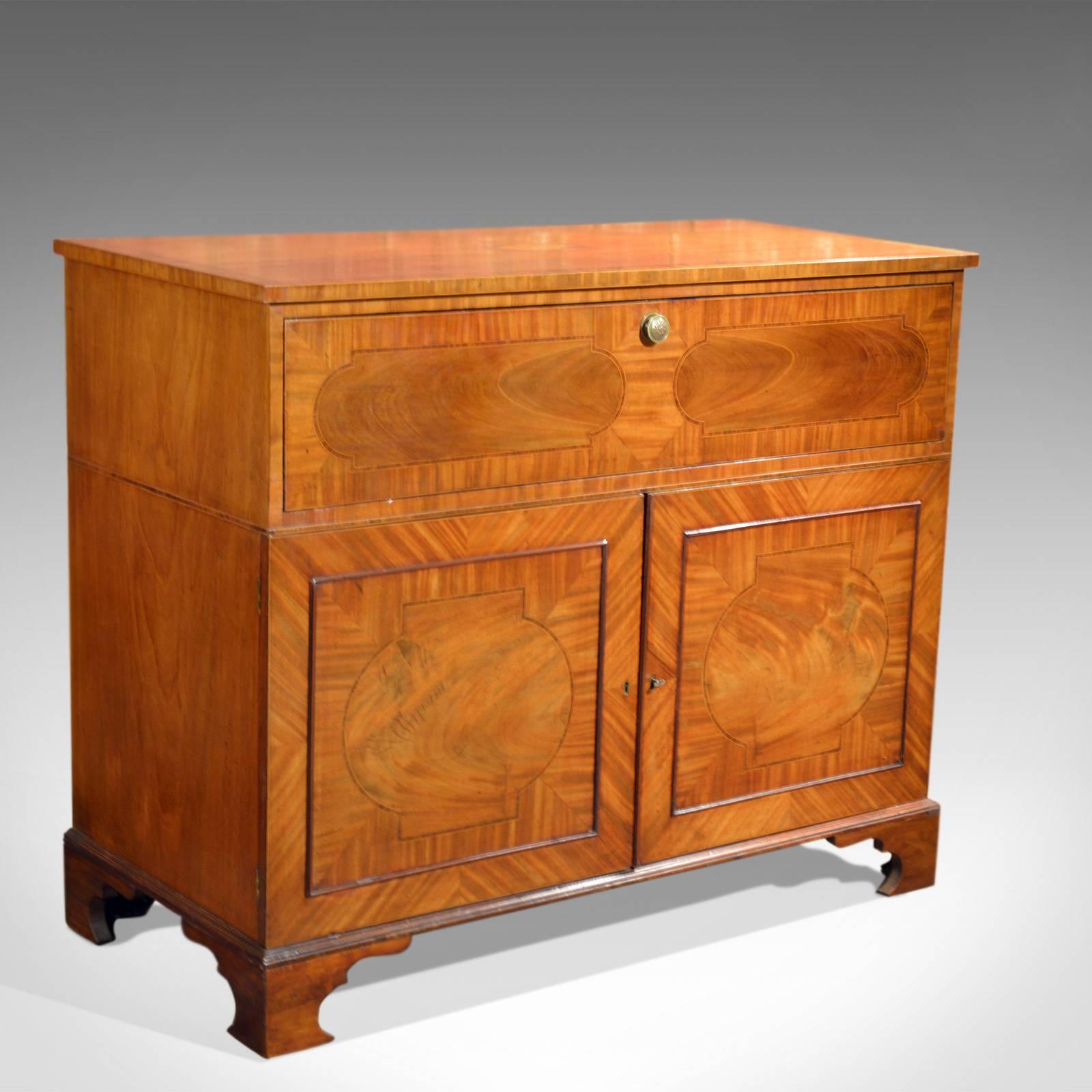 This is a mahogany antique secretaire cabinet dating to the latter part of the 18th century, circa 1780.

An attractive and functional piece of furniture it offers an upper secretaire, drop front drawer above a twin door cupboard enclosing a