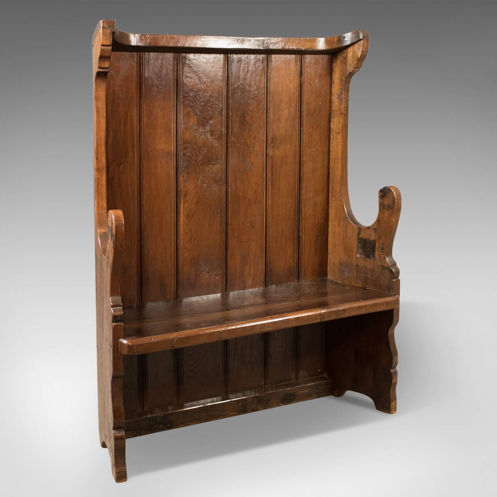 This is an antique settle, a Victorian tavern bench dating to circa 1850 with earlier origins.

Robust and solid in generous stocks of English oak
Attractive waxed finish highlighting good colour and grain interest
Victorian 17th century revival