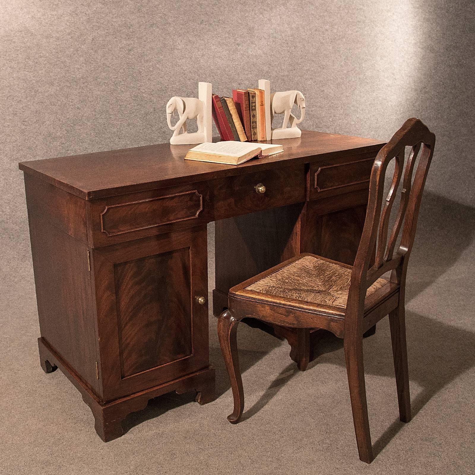 A charming English Victorian writing study desk presented in good antique condition
In mahogany with a very desirable aged tone
Stunning top showing wonderful mahogany grain and crossbanded perimeter
Rising from bracket feet
Twin cabinet doors