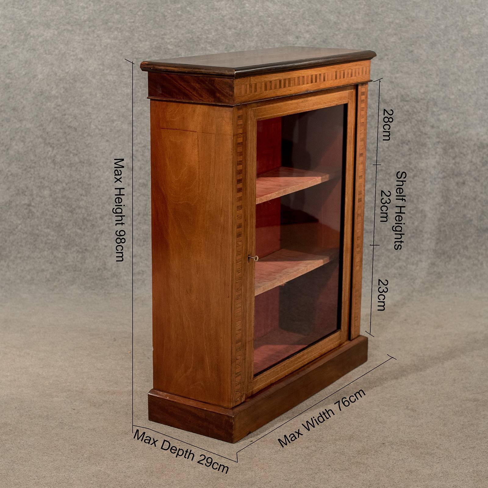 A pleasing original Victorian display pier cabinet presented in very good antique condition
With desirable inlaid marquetry to the perimeter of the central door
Original interior lining showing marks consistent with age
Locks untested as correct