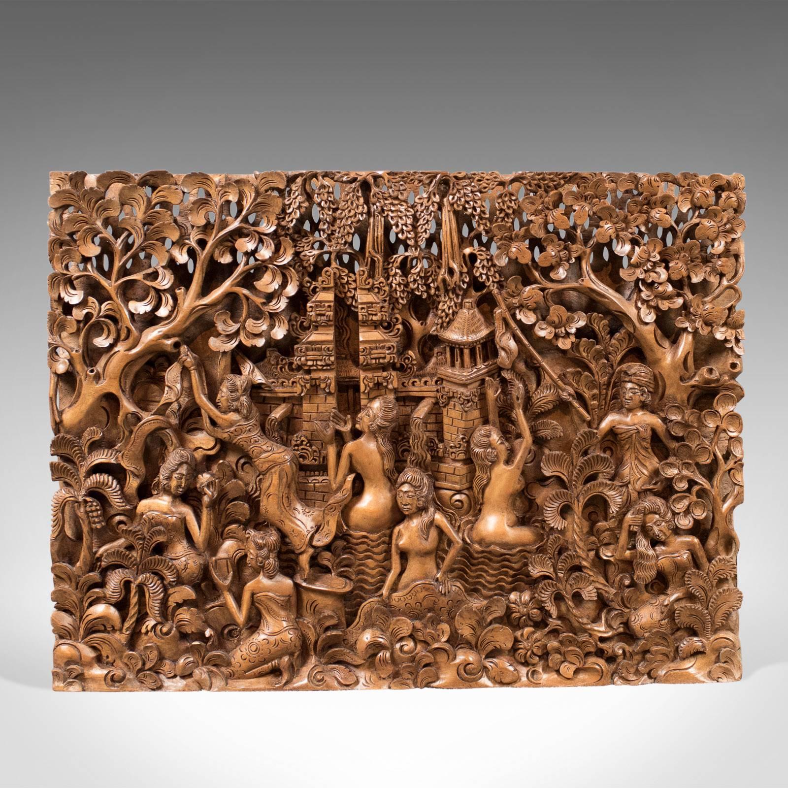 This is a Balinese carved wall panel, a piece of mid-century decorative art.

Profusely carved demonstrating exceptional skill
Created from a single, one and a half inch thick, teak slab
Abundant interest from every angle

A woodland scene of