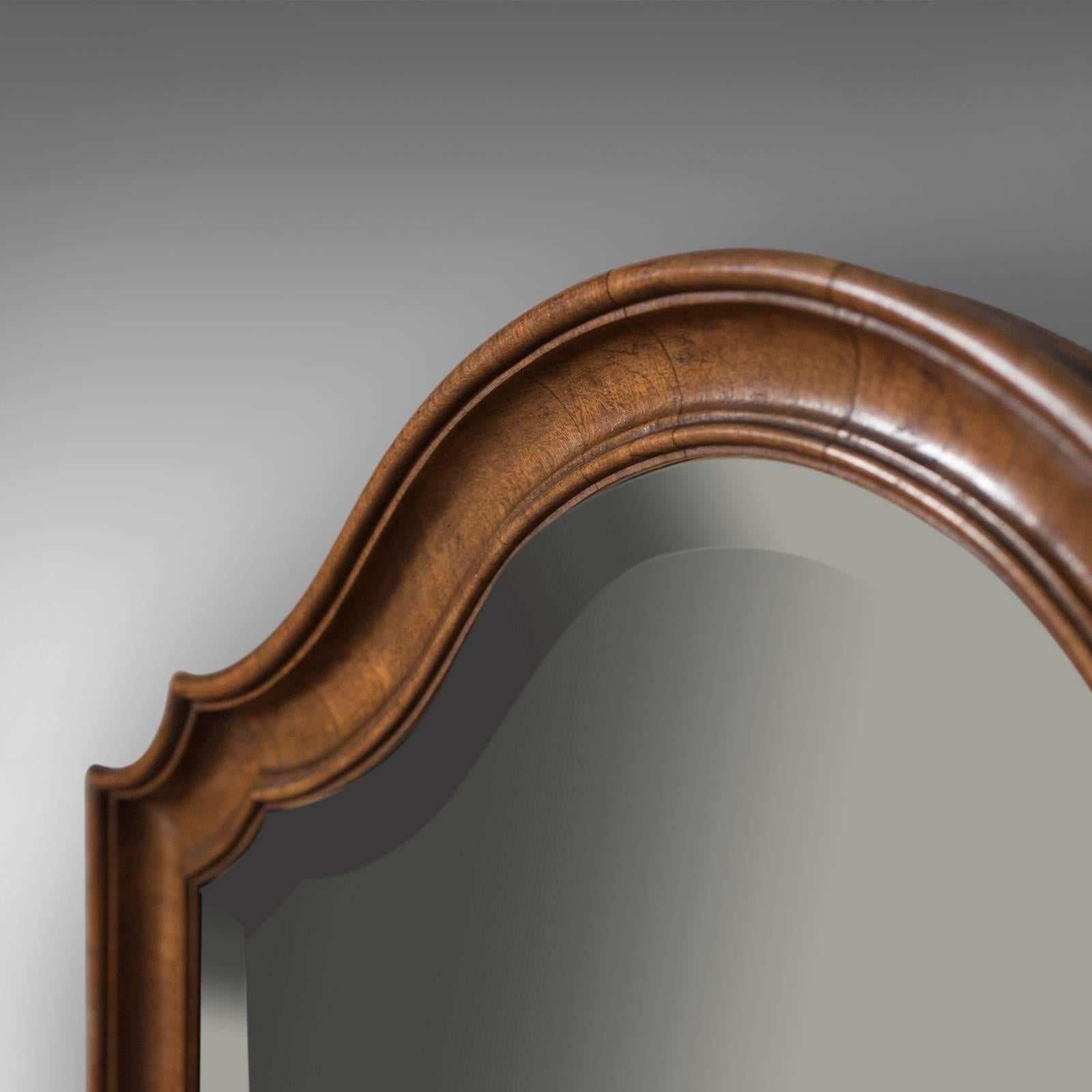 This is an antique wall mirror, English, walnut and dating to the Edwardian period, circa 1910.

From renowned cabinet maker and retailer of fine furnishings G.H. Morton & Sons Ltd.
Out of Bold Street Liverpool, this firm supplied many of the