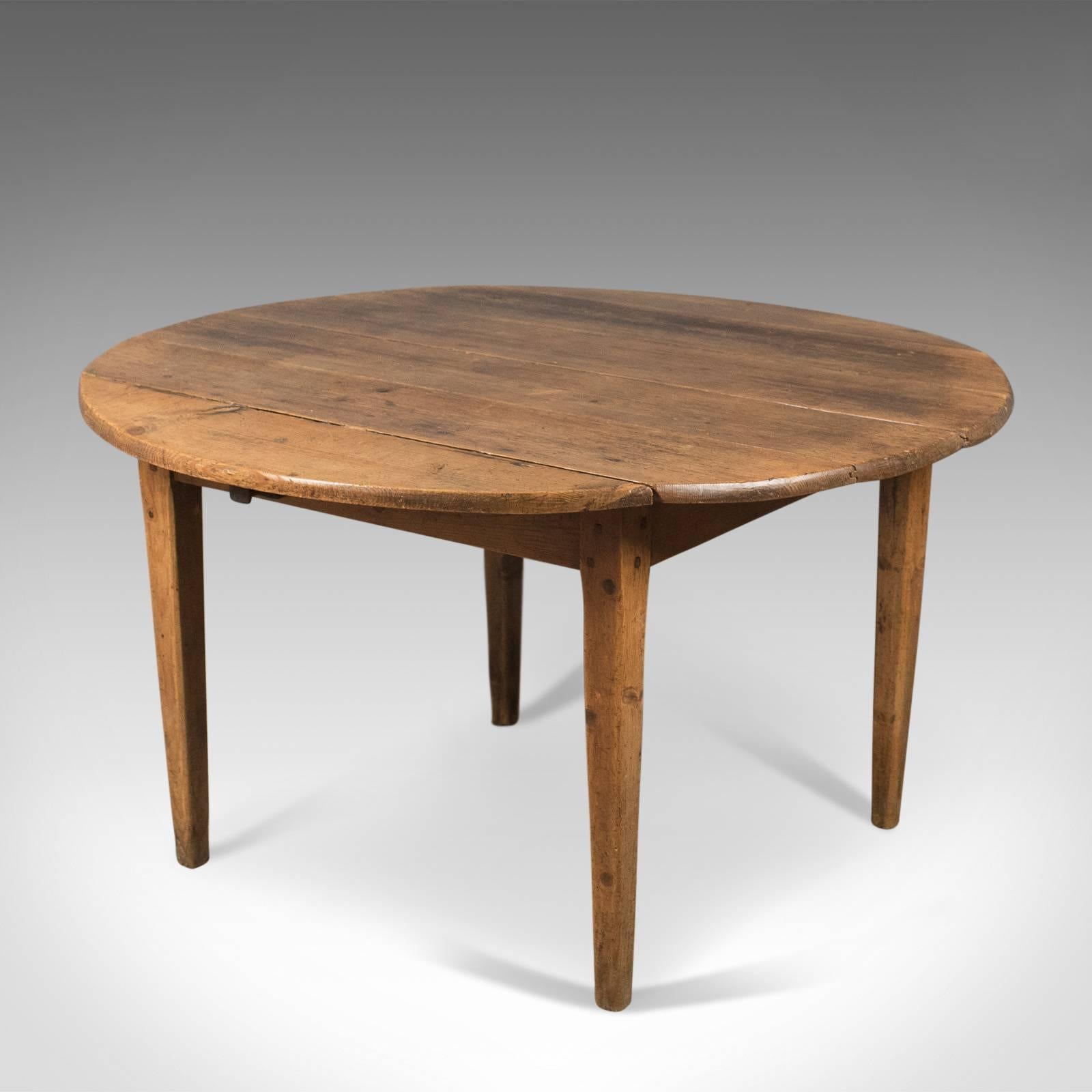 This is an antique pine table, French, kitchen dining table dating to the mid-19th century, circa 1850.

Desirable color and aged patina to the waxed antique pine
Raised on square section tapering legs with pegged joints
Four, broad plank top
