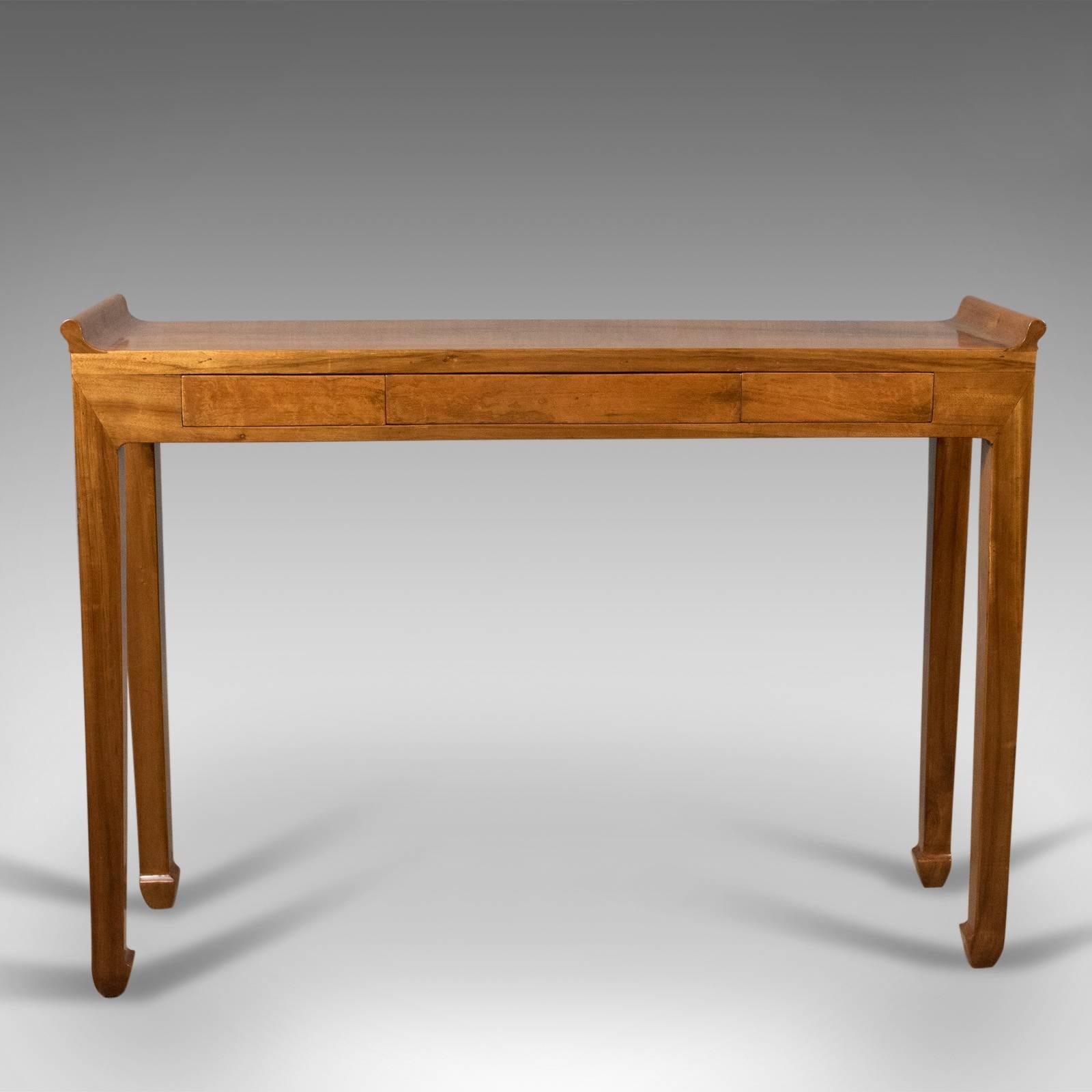 This is a midcentury hall console table, an oriental alter table in cherry dating to circa 1970.

Attractive grain detail in the light honey tones of the cheerywood
Simple, elegant form raised on square section legs with typical turned in