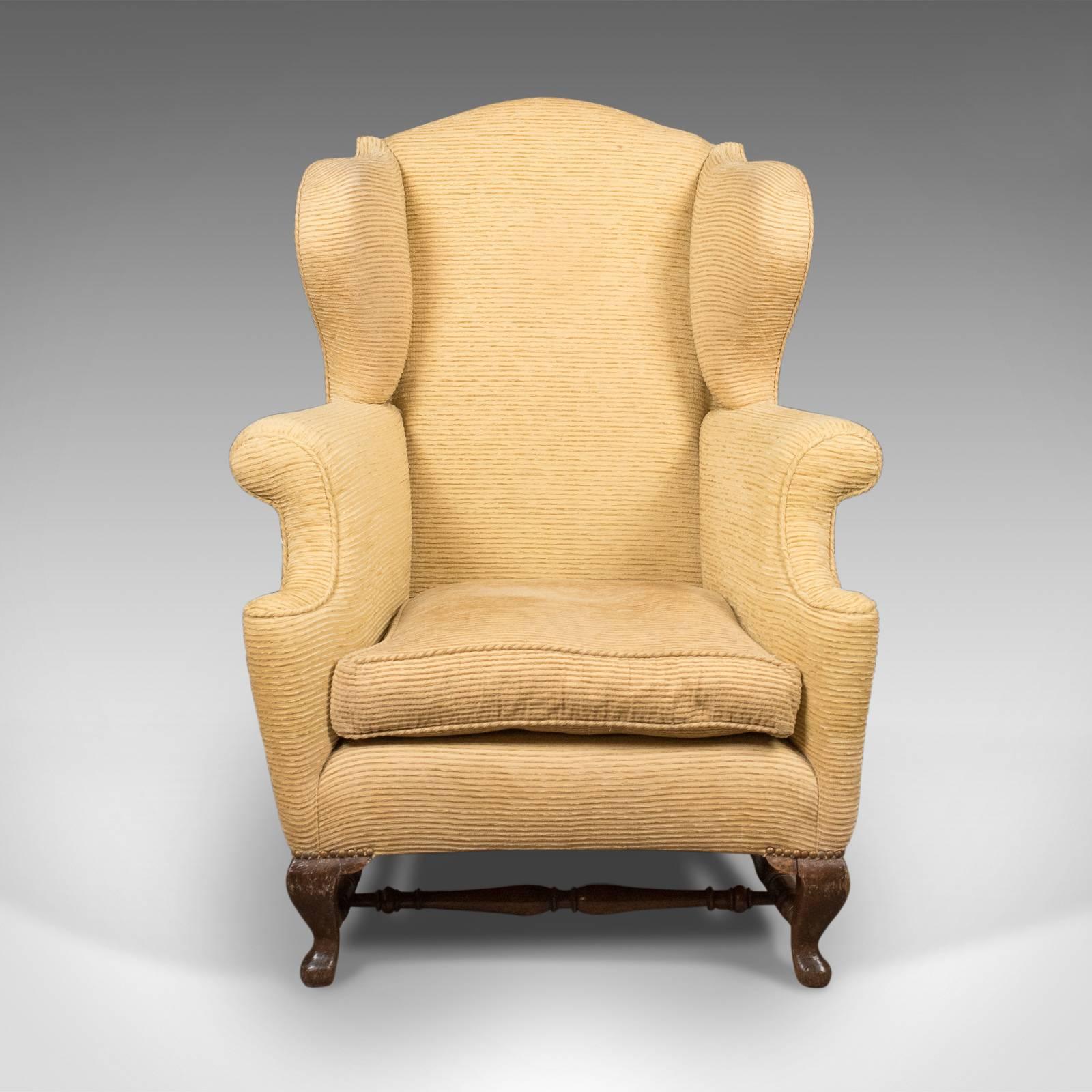 This is a late Victorian wing back armchair dating to the turn of the century, circa 1900.

A large comfortable seat with loose feather filled cushion
Well sprung and professionally upholstered
Finished in a pale mustard, corded cloth ready to
